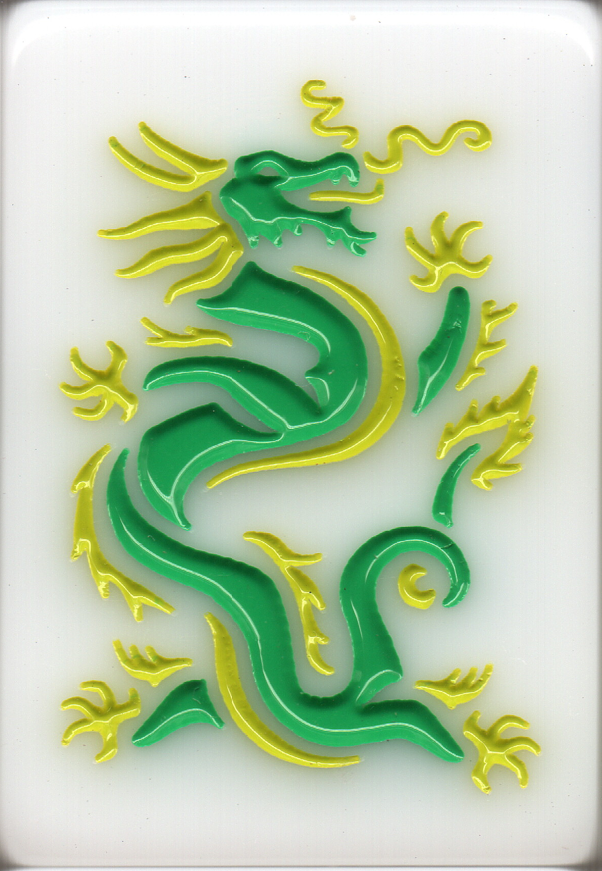 Glass artwork of a green dragon with yellow accents on a clear background.