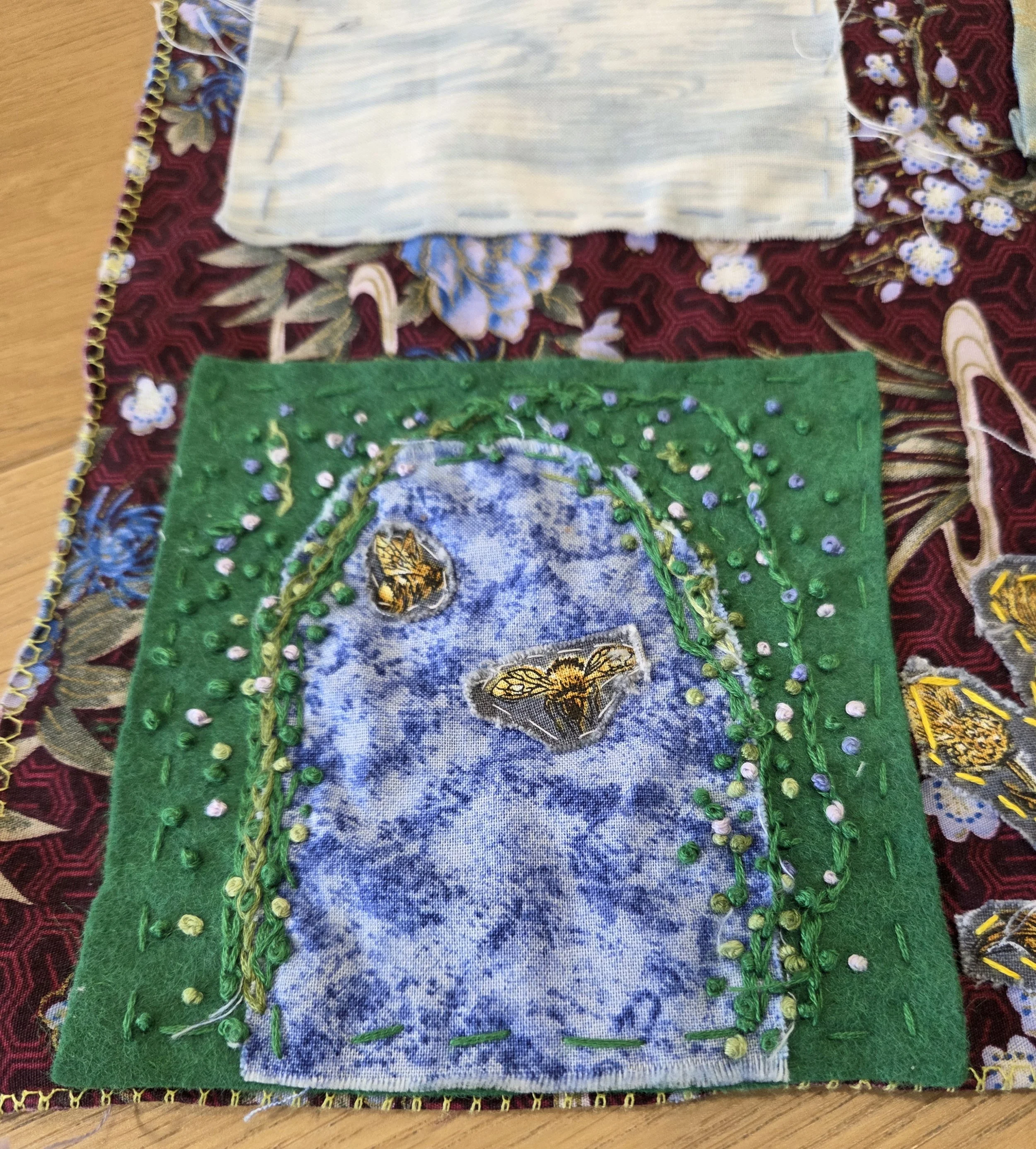 Embroidered fabrics representing a garden archway on a Scottish holiday