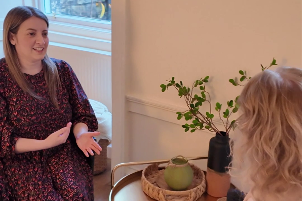 Reiki practitioner speaking coaching another Reiki practitioner during a one-to-one mentoring session