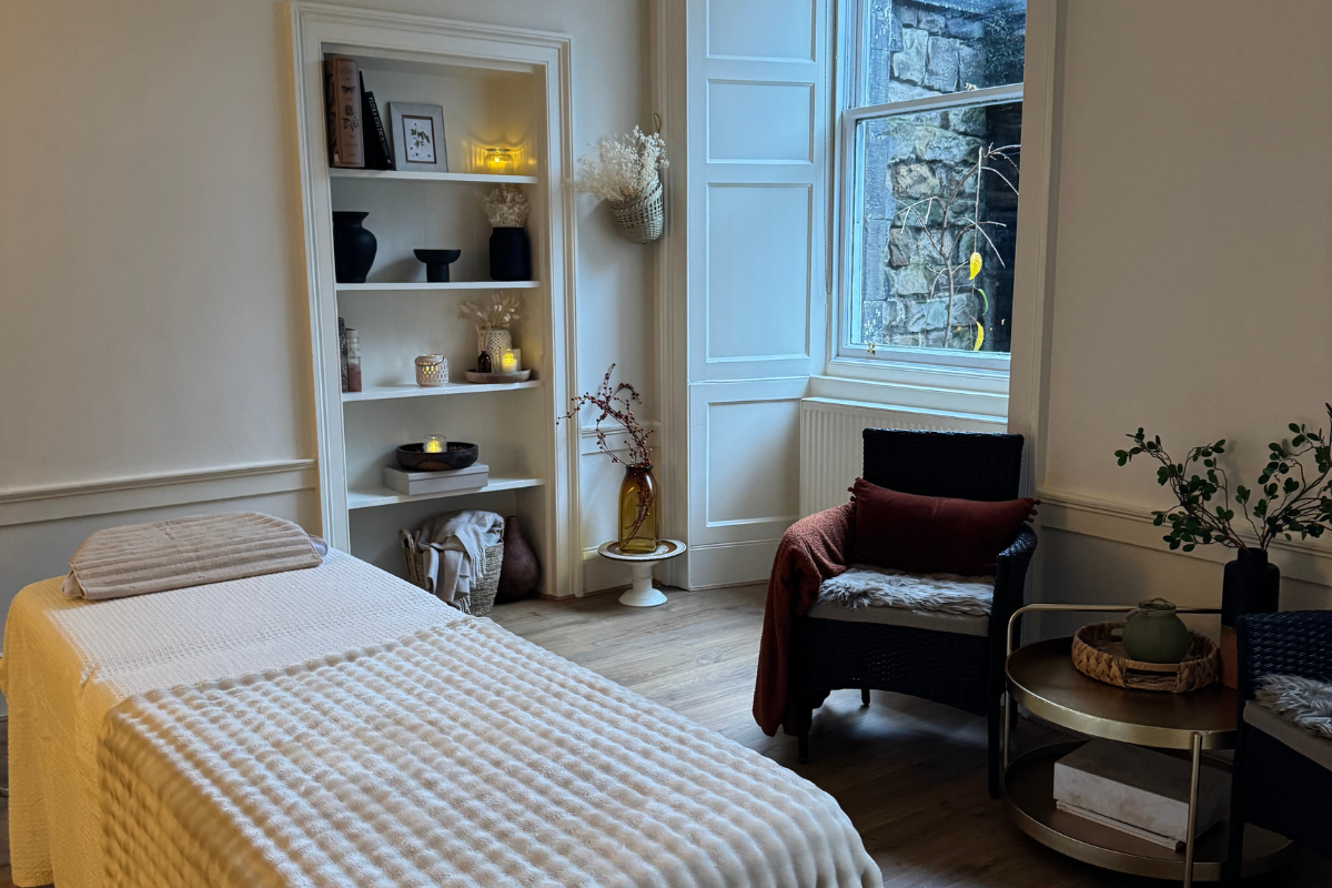 Calm and welcoming Reiki treatment room with massage table and natural decor