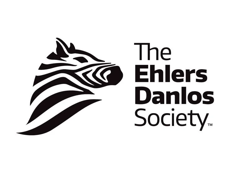 Logo of The Ehlers Danlos Society featuring a stylized zebra head in black and white.