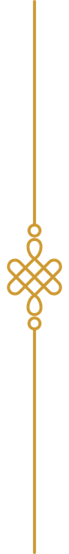 Decorative gold ornament hanging from a string.