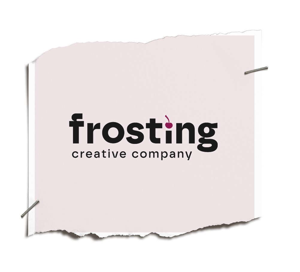 A pink and white sign for Frosting creative company, with the word frosting in bold black letters and a cherry substituting the dot over the 'i'.