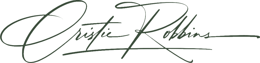 Signature of Cristie Robbins in elegant cursive handwriting.