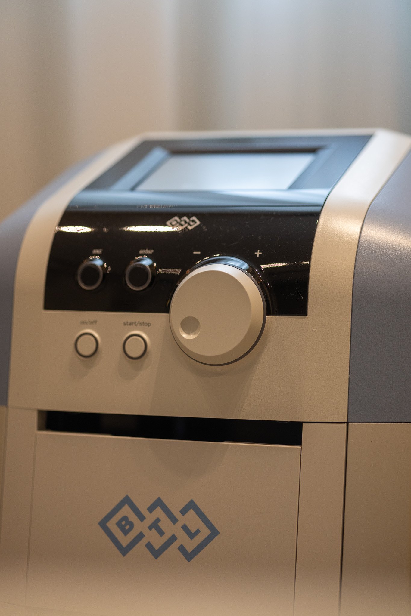 Close-up of a voting or ballot scanning device with a small screen and control buttons, placed on a surface with a logo reading 'BLOCKCHAIN'.