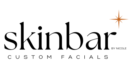 Logo for Skinbar by Nicole featuring the words 'Skinbar' and 'Custom Facials' with a starburst graphic.