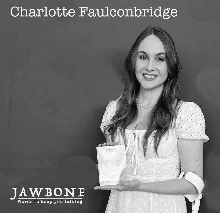 A woman with long wavy hair smiling and holding a small book or pamphlet in front of a plain wall. The image includes text with her name, Charlotte Falconbridge, and a tagline for Jawbone that reads "Words to keep you talking."