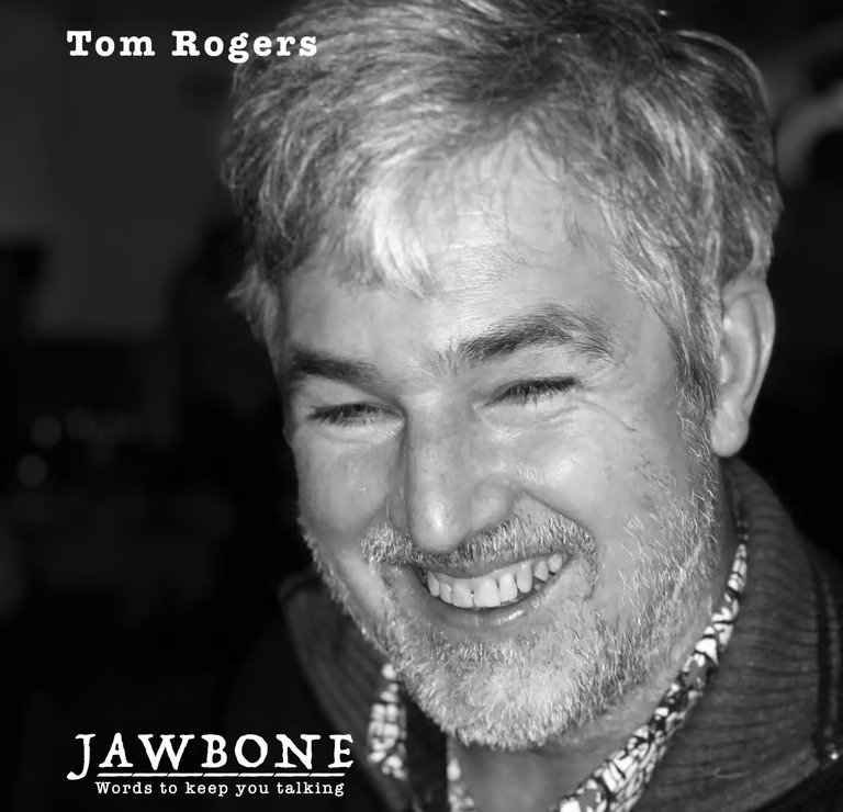 Black and white photo of Tom Rogers smiling, with text indicating the book title 'Jawbone' and the publisher's slogan 'Words to keep you talking'