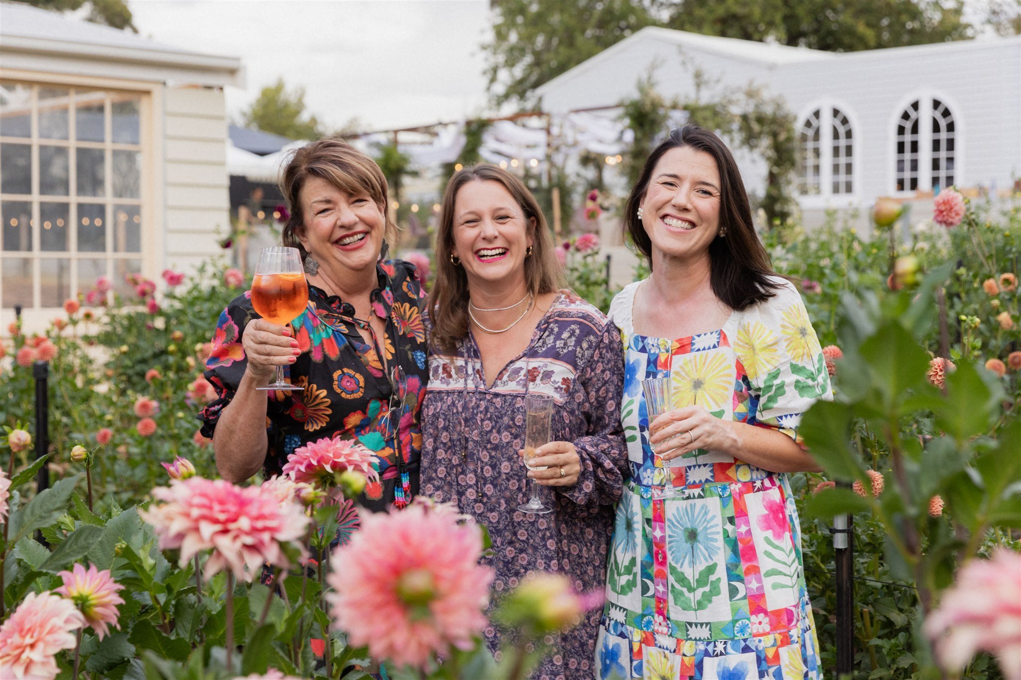 Three Blume Retreat attendees enjoying time together among the dahlias
