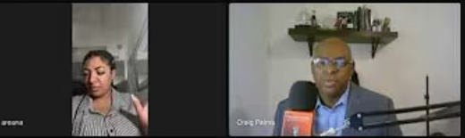 Screenshot of two people in a virtual meeting, one woman and one man with glasses, sitting in front of a wall with a shelf.