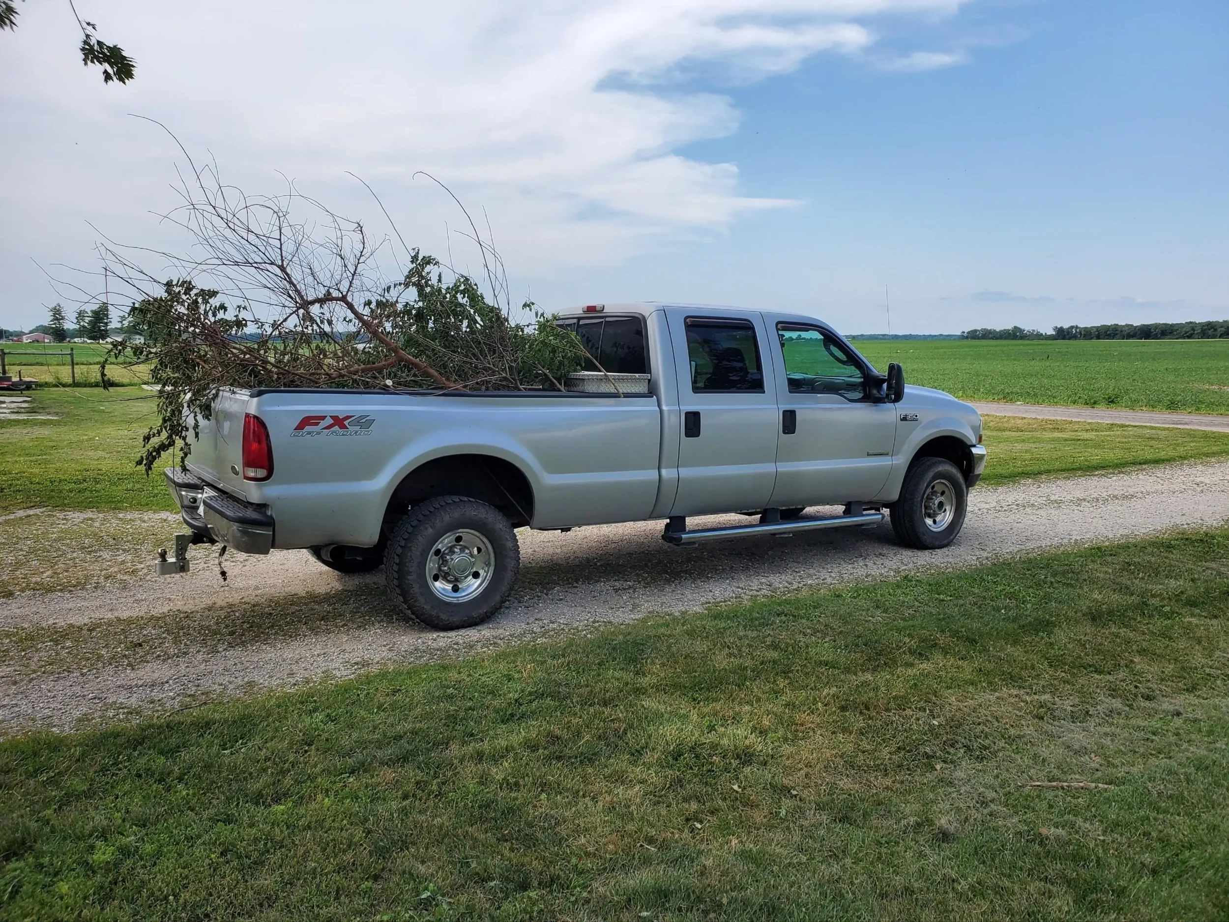 Junk Solutions LLC truck loaded with branches and yard waste for removal in Bluffton, Indiana