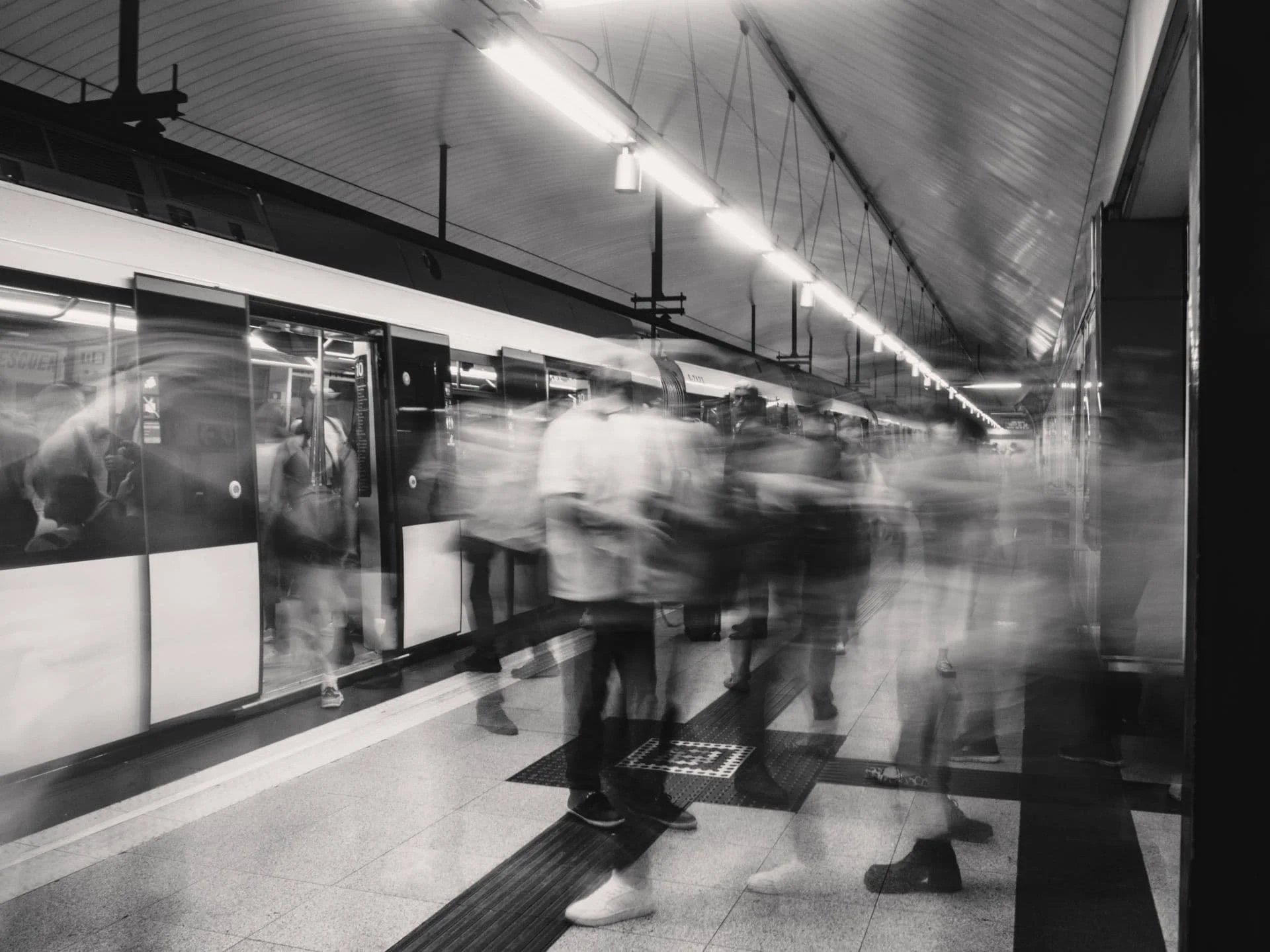 Blurred people walking on a train platform