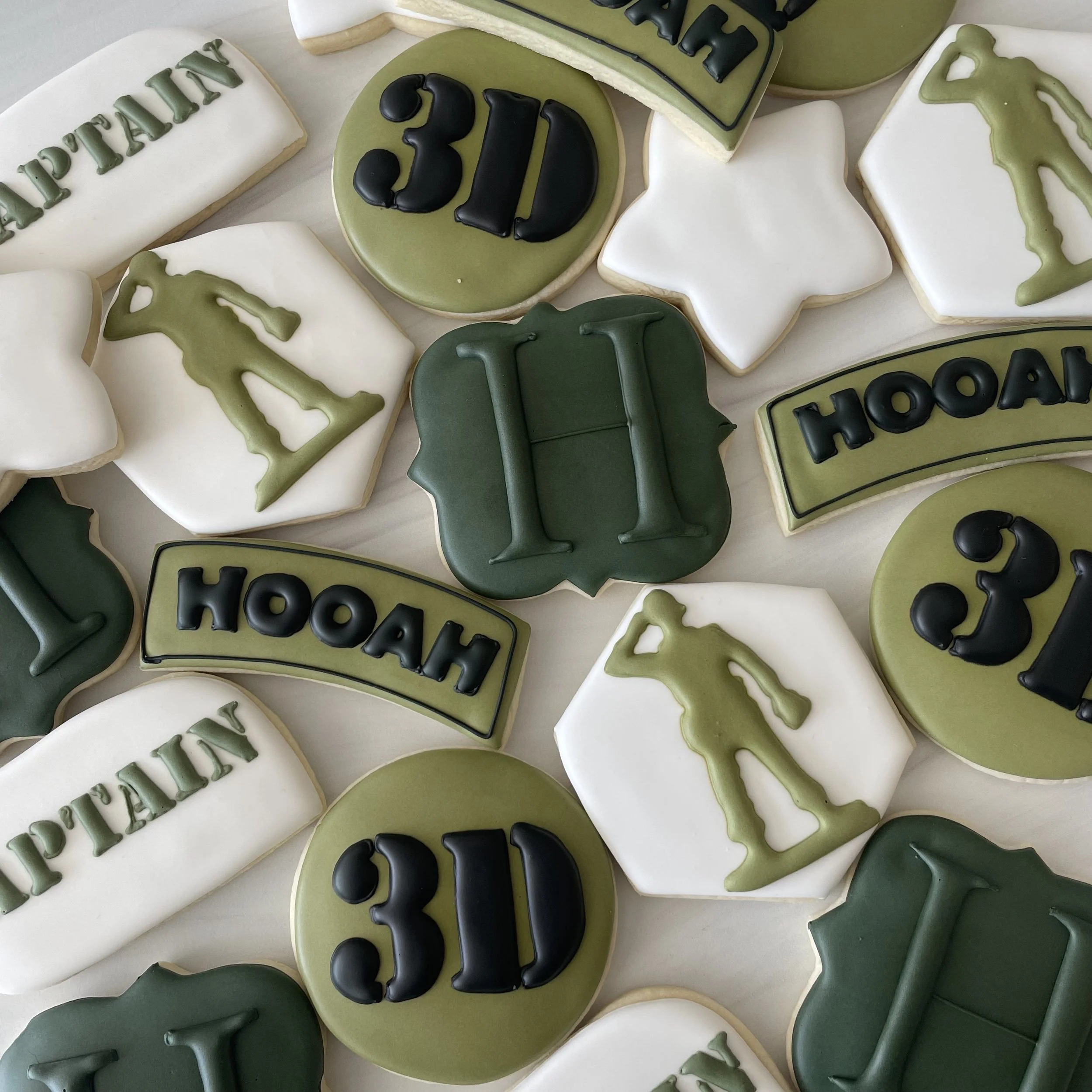 Cookies decorated with green, black, and white icing spelling out 'HAPPY 30' and shaped like cars and stars.