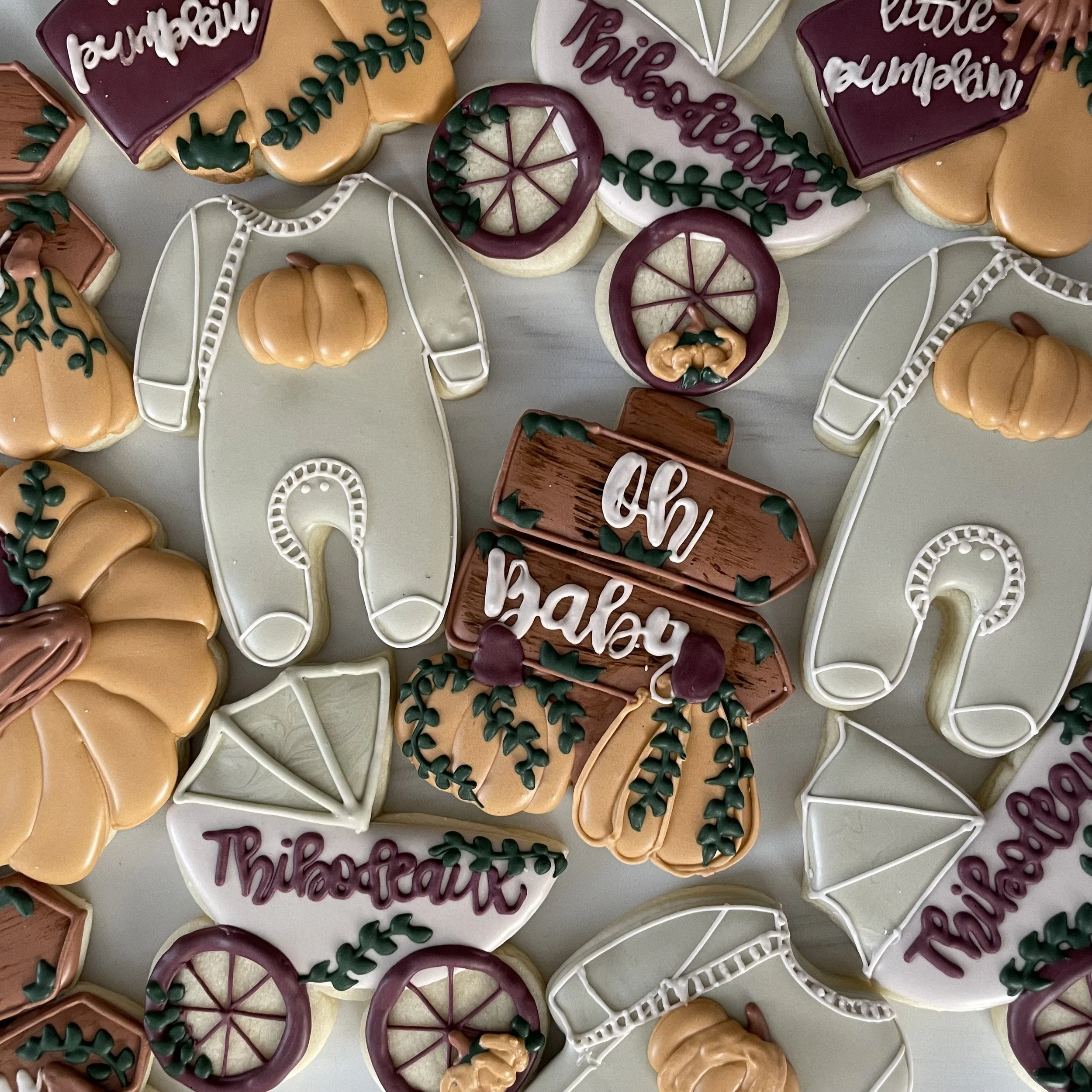 Assorted decorated sugar cookies with fall-themed and Thanksgiving messages and designs, including pumpkins, leaves, and phrases like "Thankful" and "Grateful".