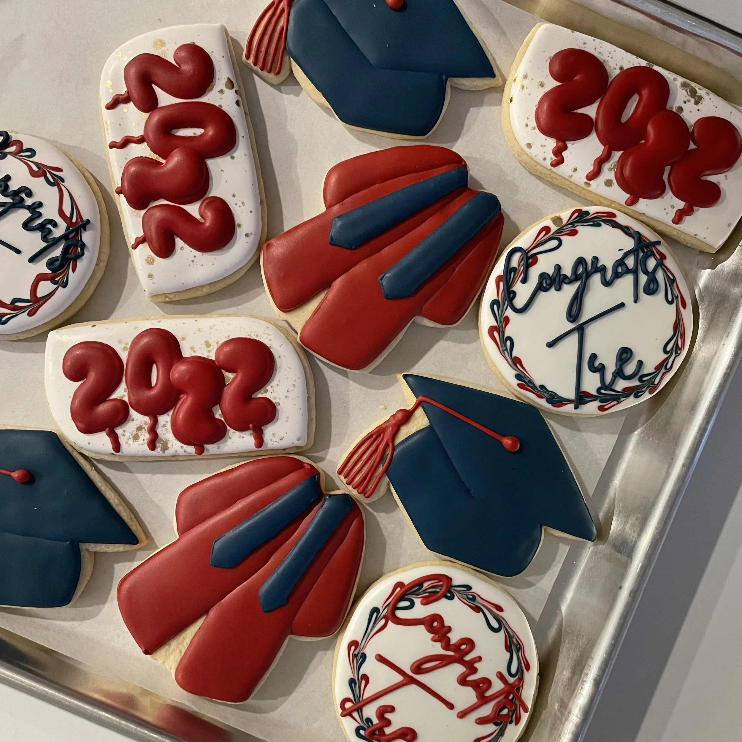 Decorated cookies with red, white, and blue colors, featuring messages and symbols related to celebrating the 4th of July.