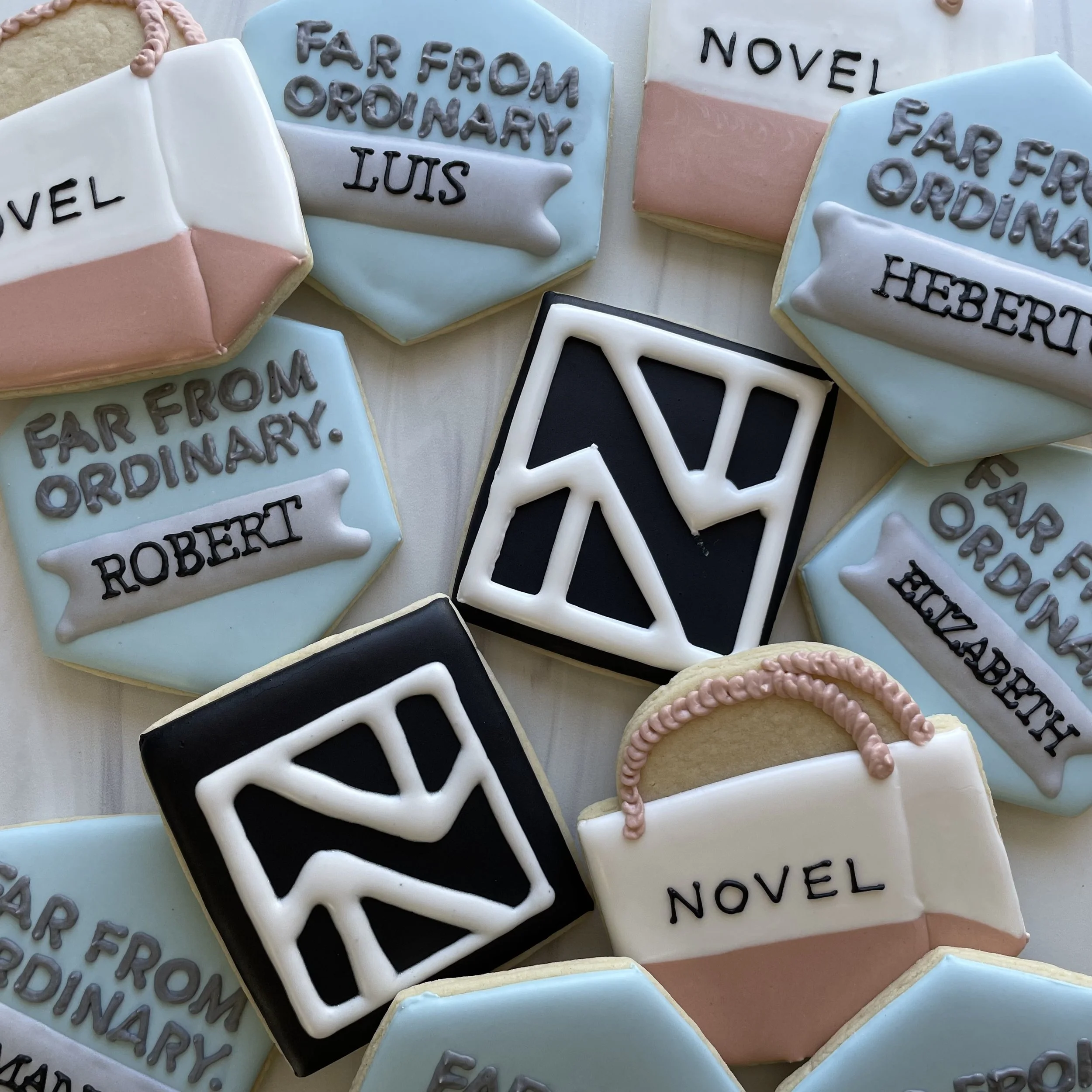 Decorative cookies with messages about the Harry Potter book series, featuring blue, white, pink, black, and gray icing, with text such as 'Far From Ordinary,' 'Herbf,' 'Move,' and 'For.'