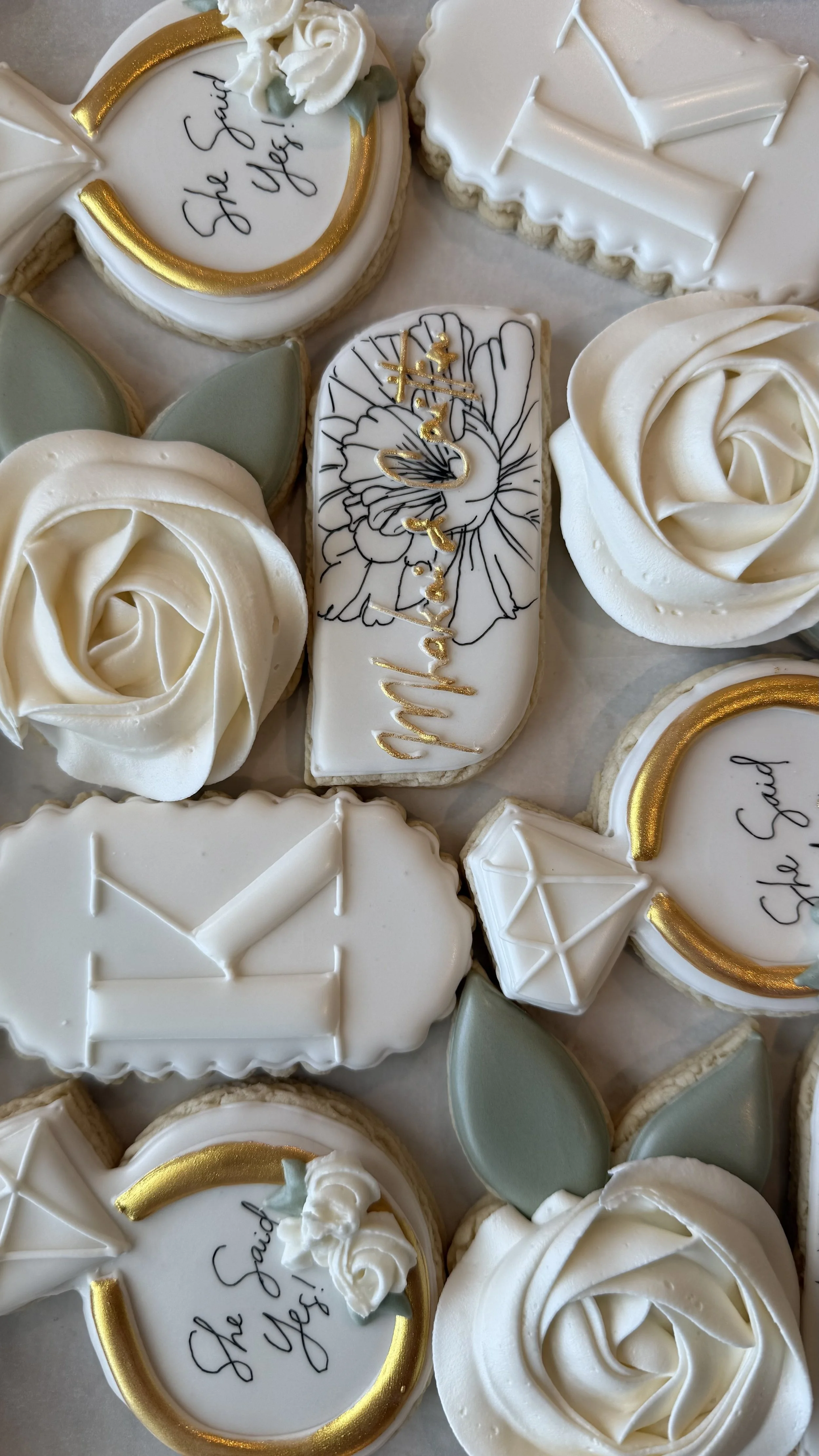 Decorative cookies with white, gold, and green icing, some with floral designs, and a message that says "The Soul of the Bride!"