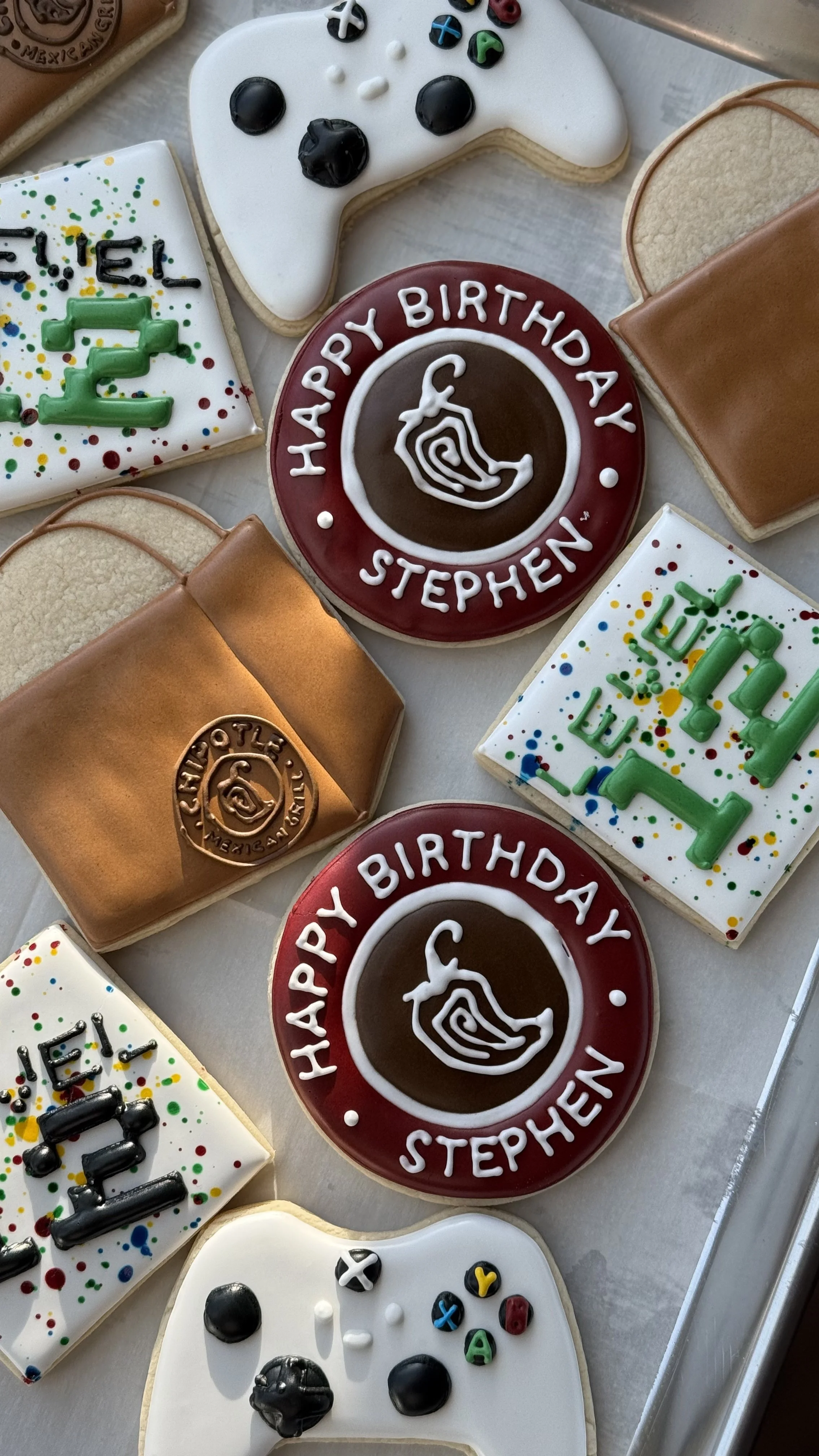 Decorated birthday cookies with video game and Xbox theme, including game controllers and personalized messages.