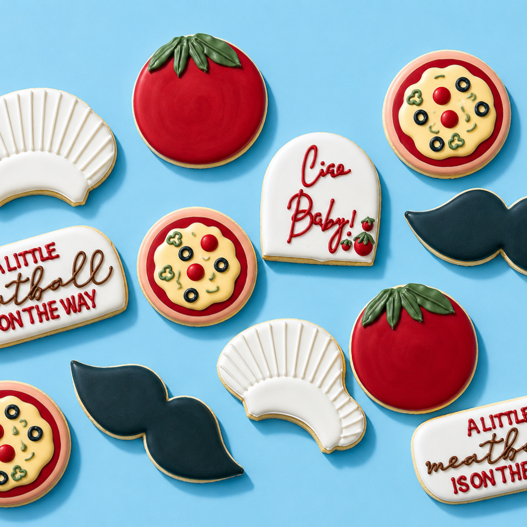 Decorative cookies shaped like a tomato, pizza, mustache, shells, and text that says 'Ciao Baby!' and 'ALITTLE meath ISON THEWAY' on a blue background.