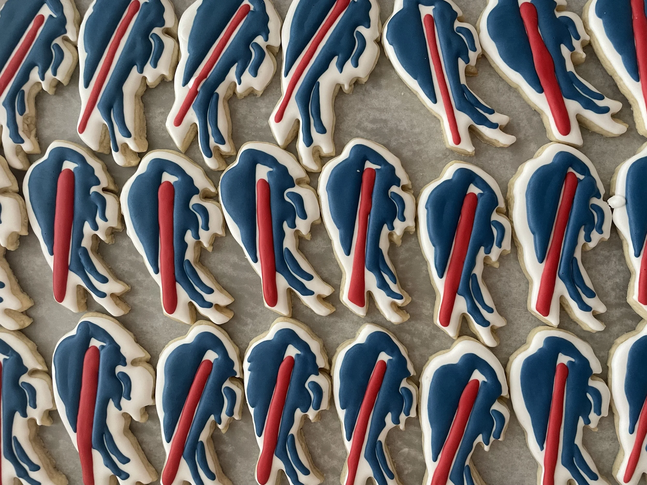 A group of cookies decorated with white, blue, and red icing, resembling the American flag.