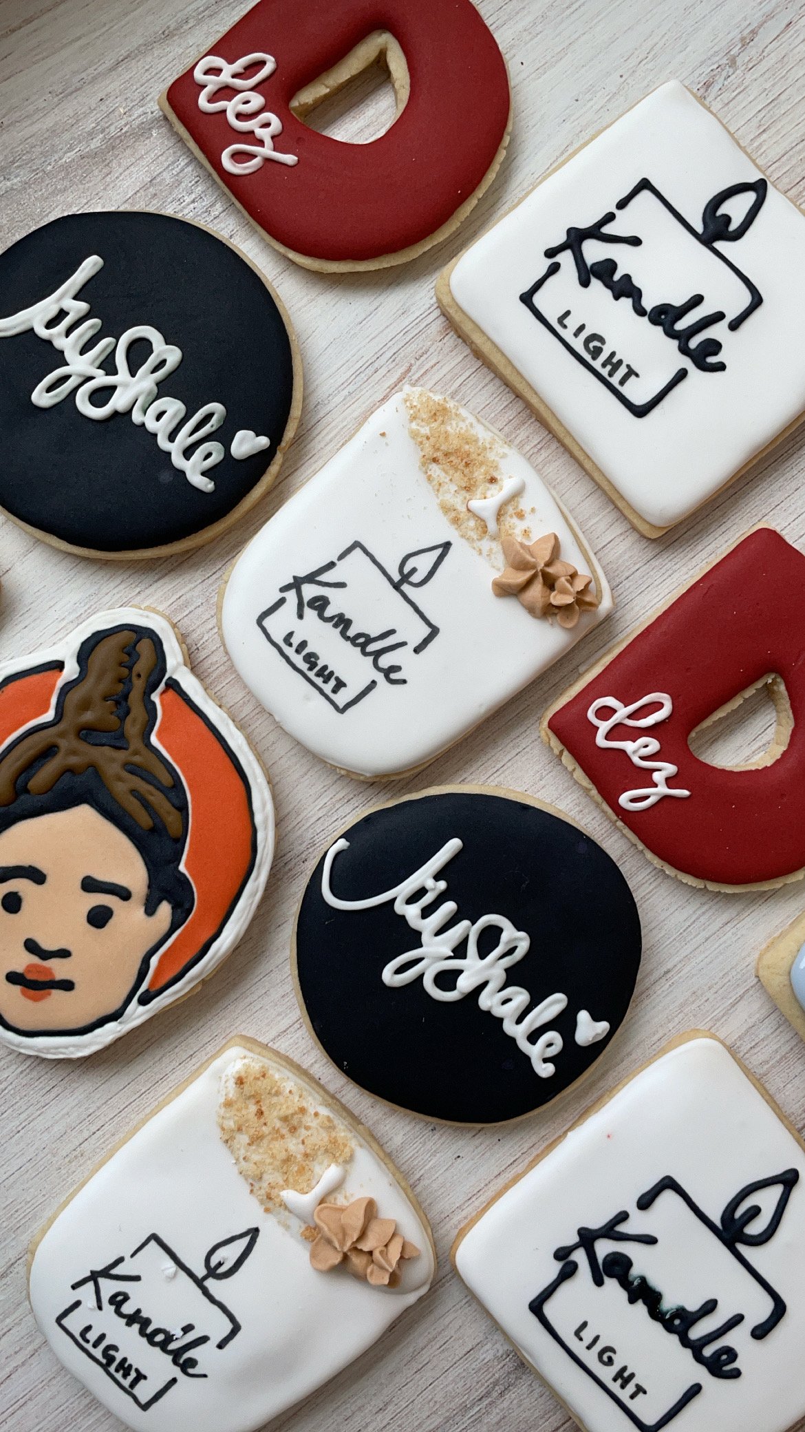 Decorated cookies with messages and illustrations, including a cookie with the words 'please' and a heart, a cookie with 'thank you' inside a house outline, and cookies with the words 'thank you' and 'please'.