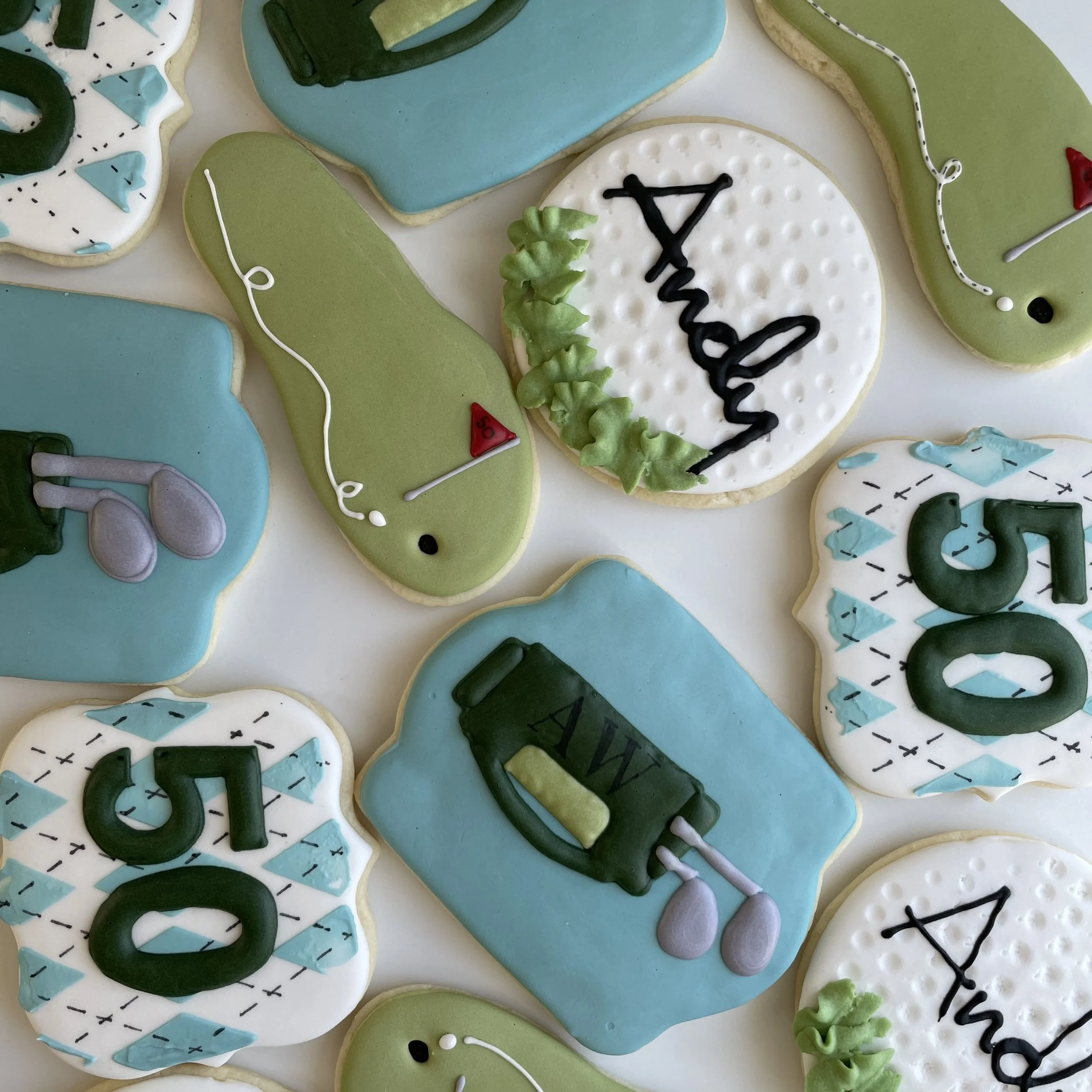 Close-up of decorated cookies with golf theme including golf balls, course, and equipment