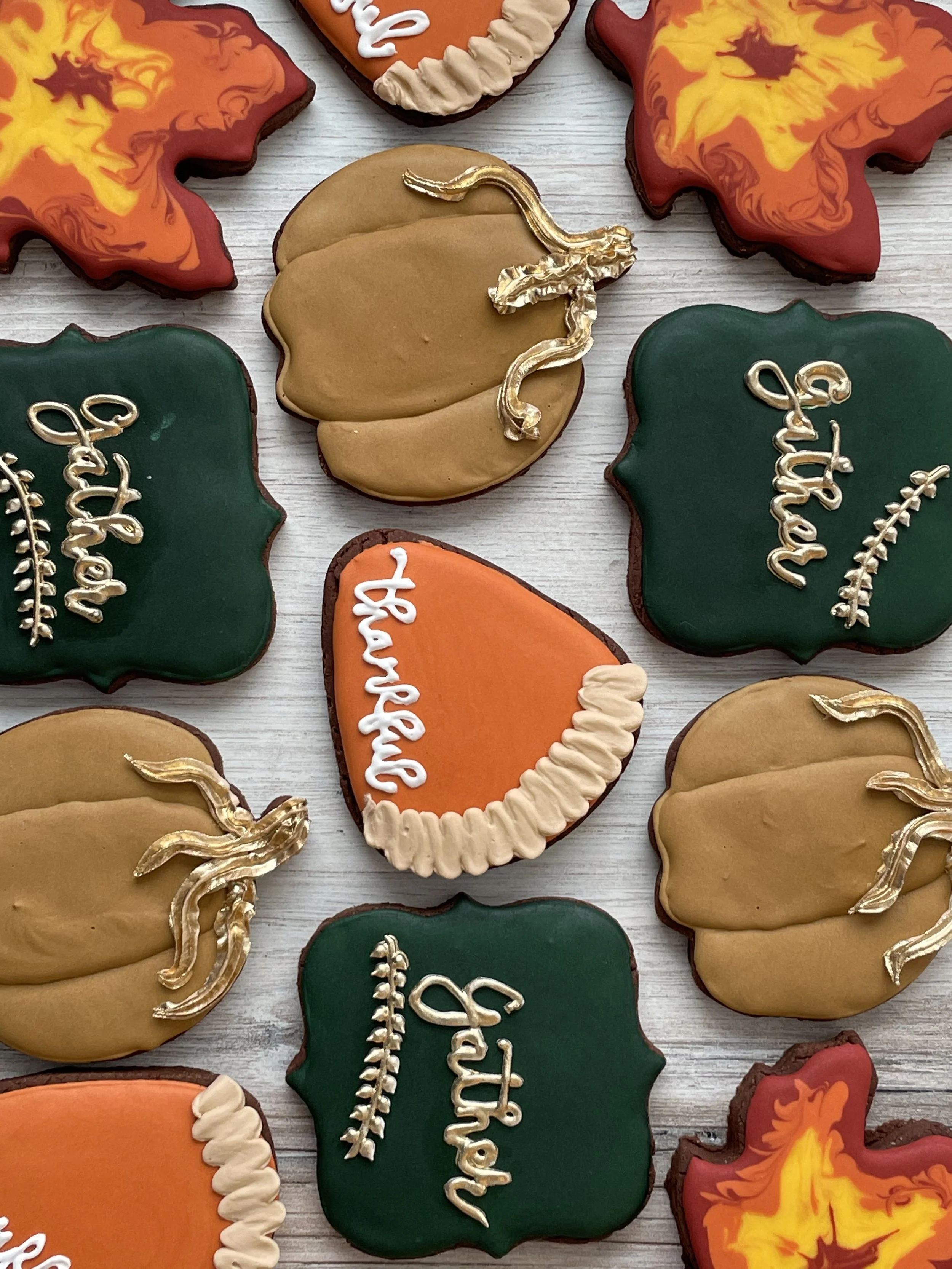 Colorful Halloween cookies decorated with flames, pumpkins, and 'Happy Halloween' messages.