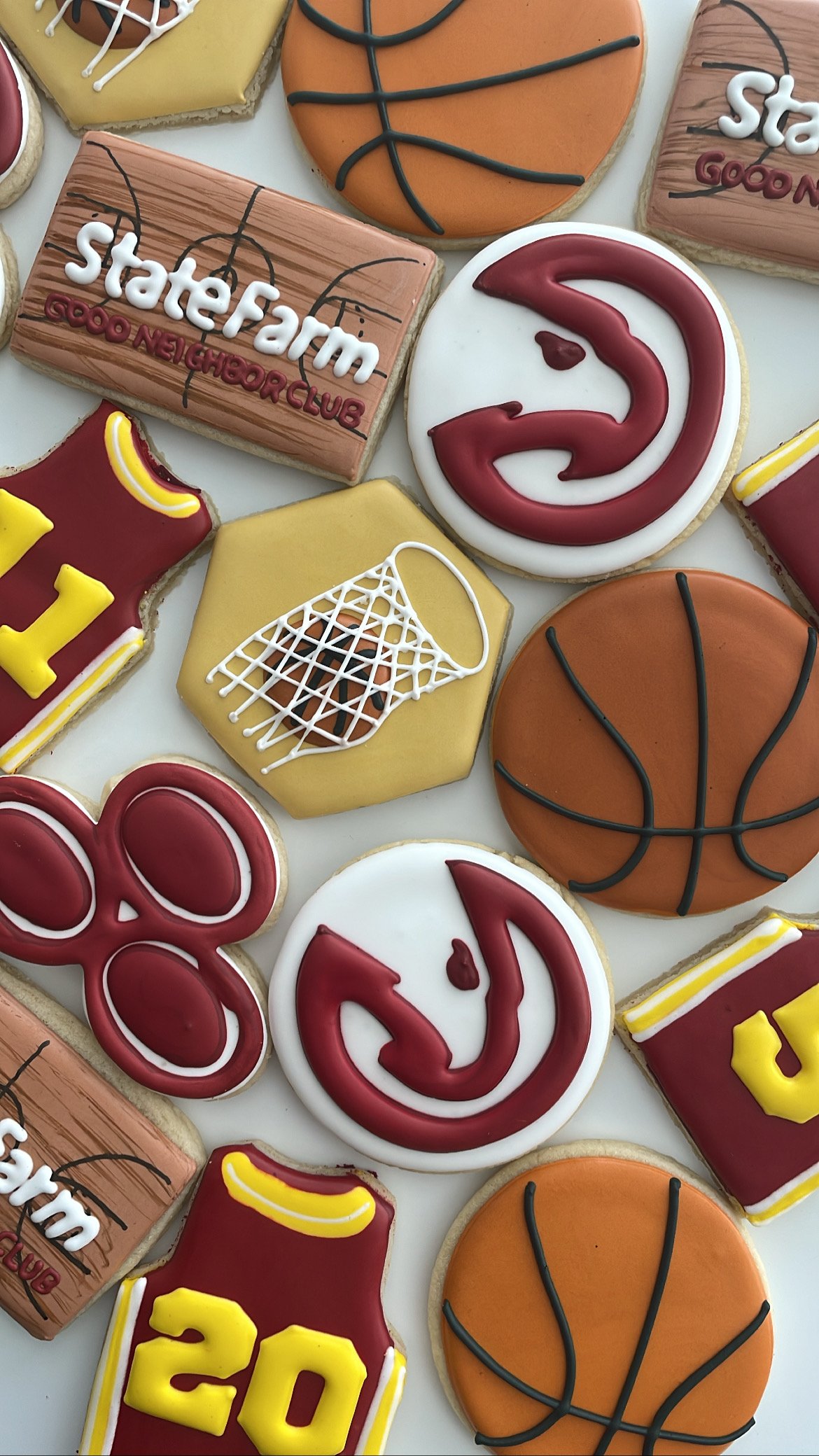 Assorted cookies decorated with basketball, Atlanta Hawks logo, and team-themed messages.