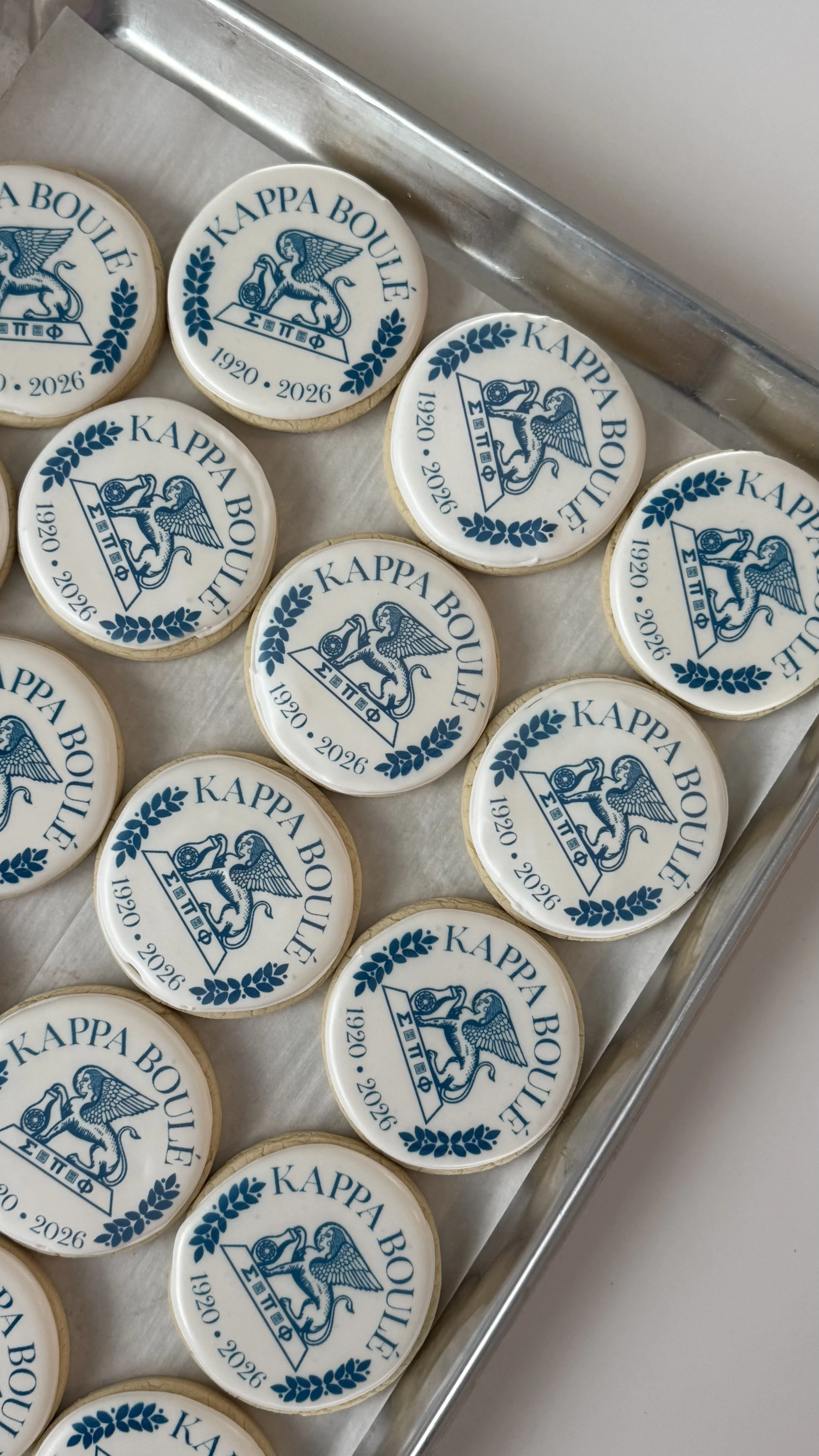 Cookies with the Kappa Boulé logo, featuring a winged lion emblem, laurel wreath border, and the years 1920 and 2026.