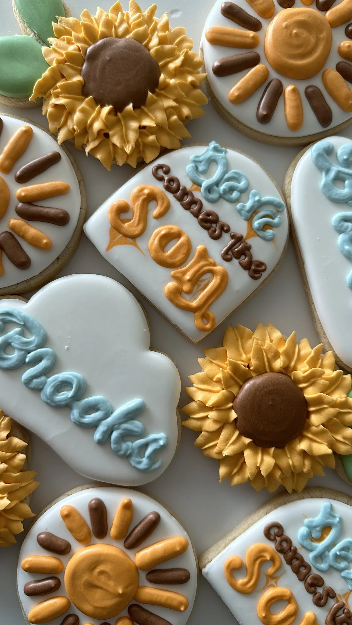 Assorted decorated cookies, including sunflowers, hearts, and cookies with 'Sofia' and the date '2023' written on them.