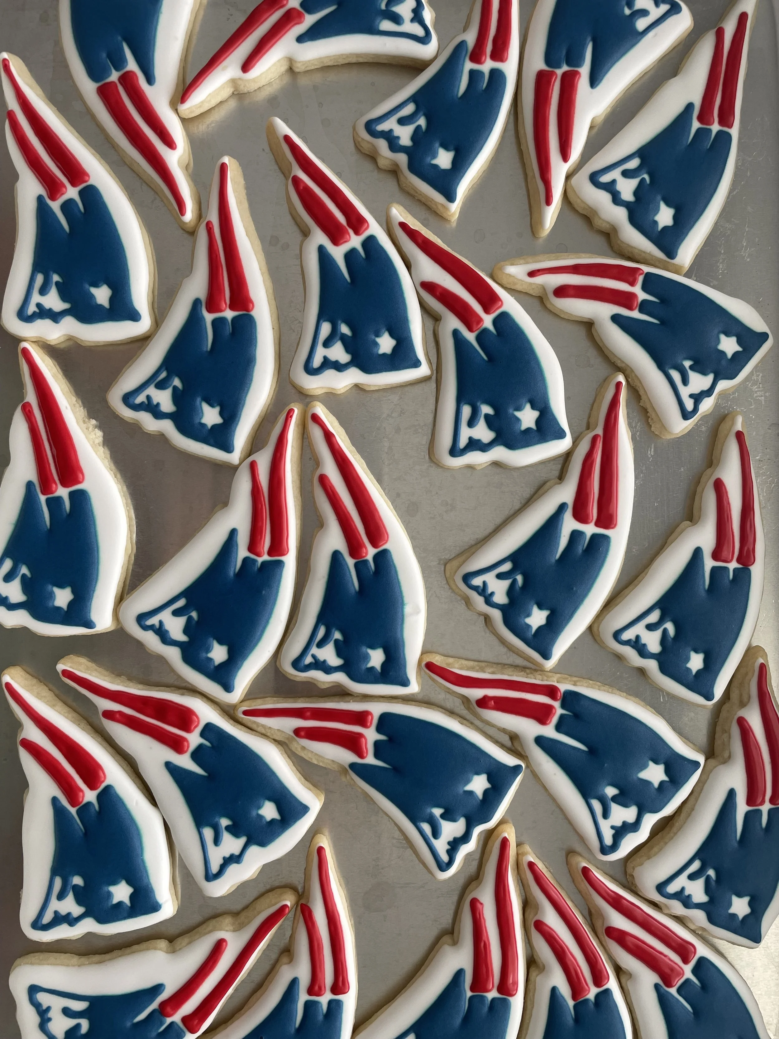 Cookies decorated with red, white, and blue icing in an American flag theme.