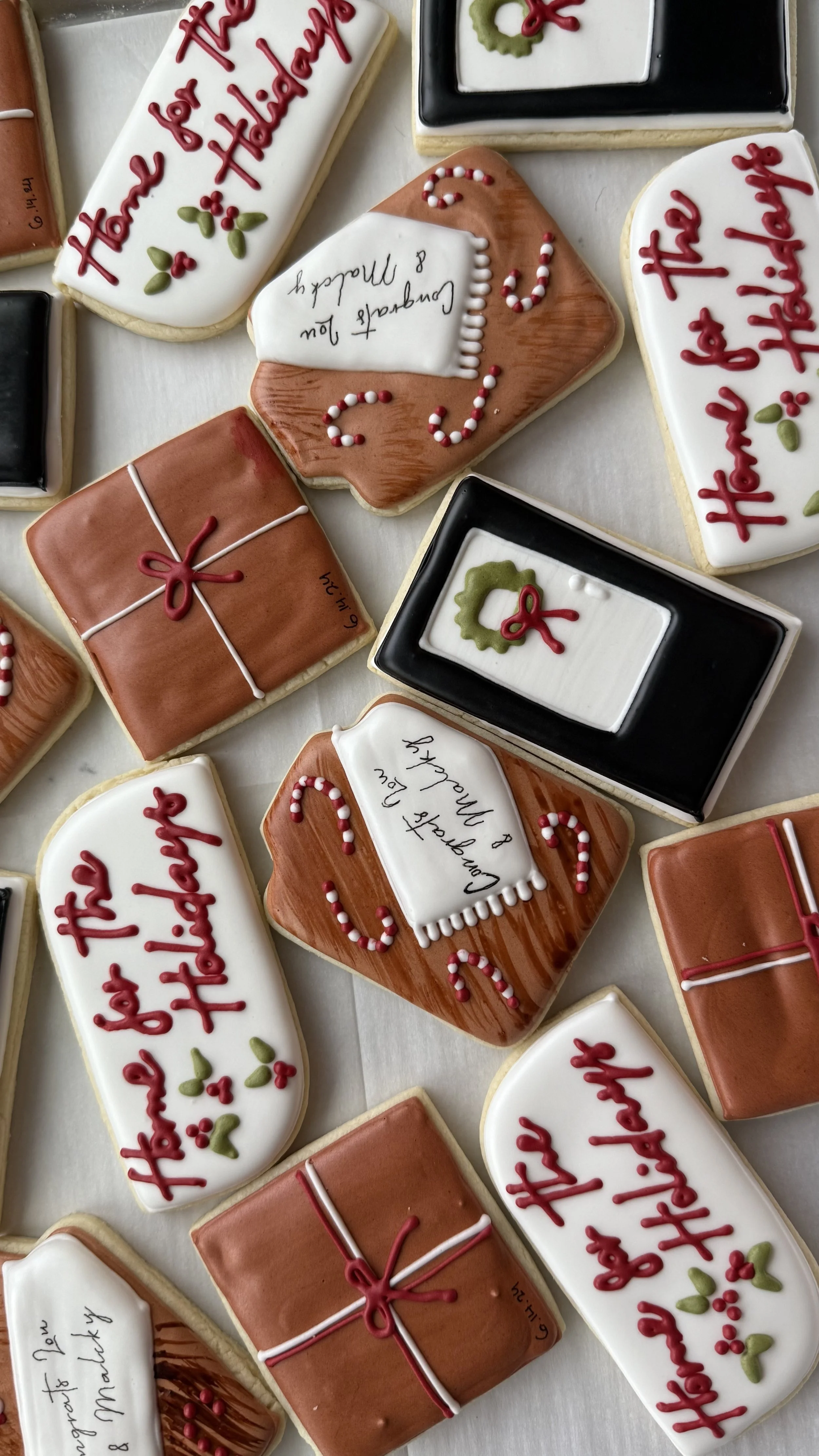 Collection of decorated holiday cookies with Christmas themes and messages.