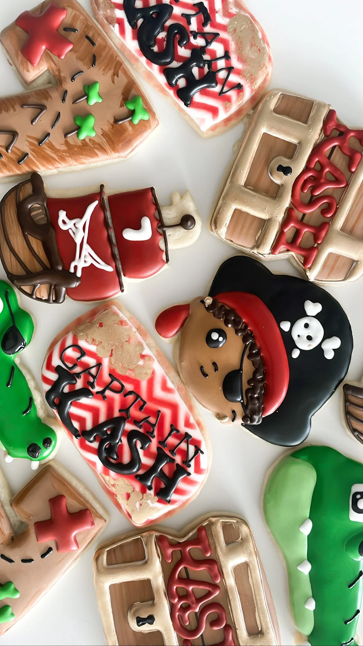 Assorted decorated cookies with letter and shape designs, some with themes like pirates, the 4th of July, and St. Patrick's Day.