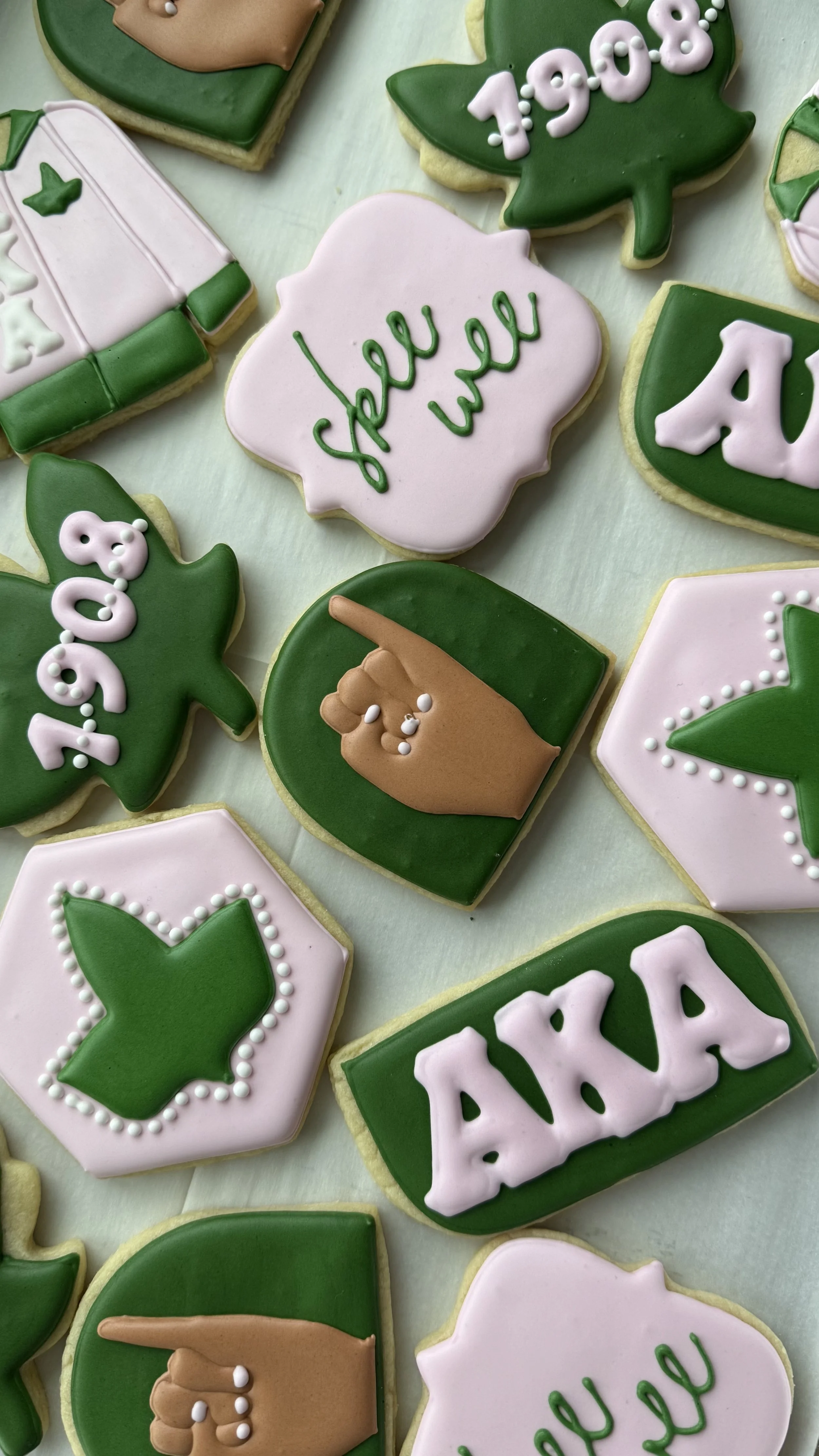 Decorated cookies with holiday and New Year's themes, including the words "hello" and "peace," a hand gesture, a gift box, and a calendar showing 1. 1. 2023.