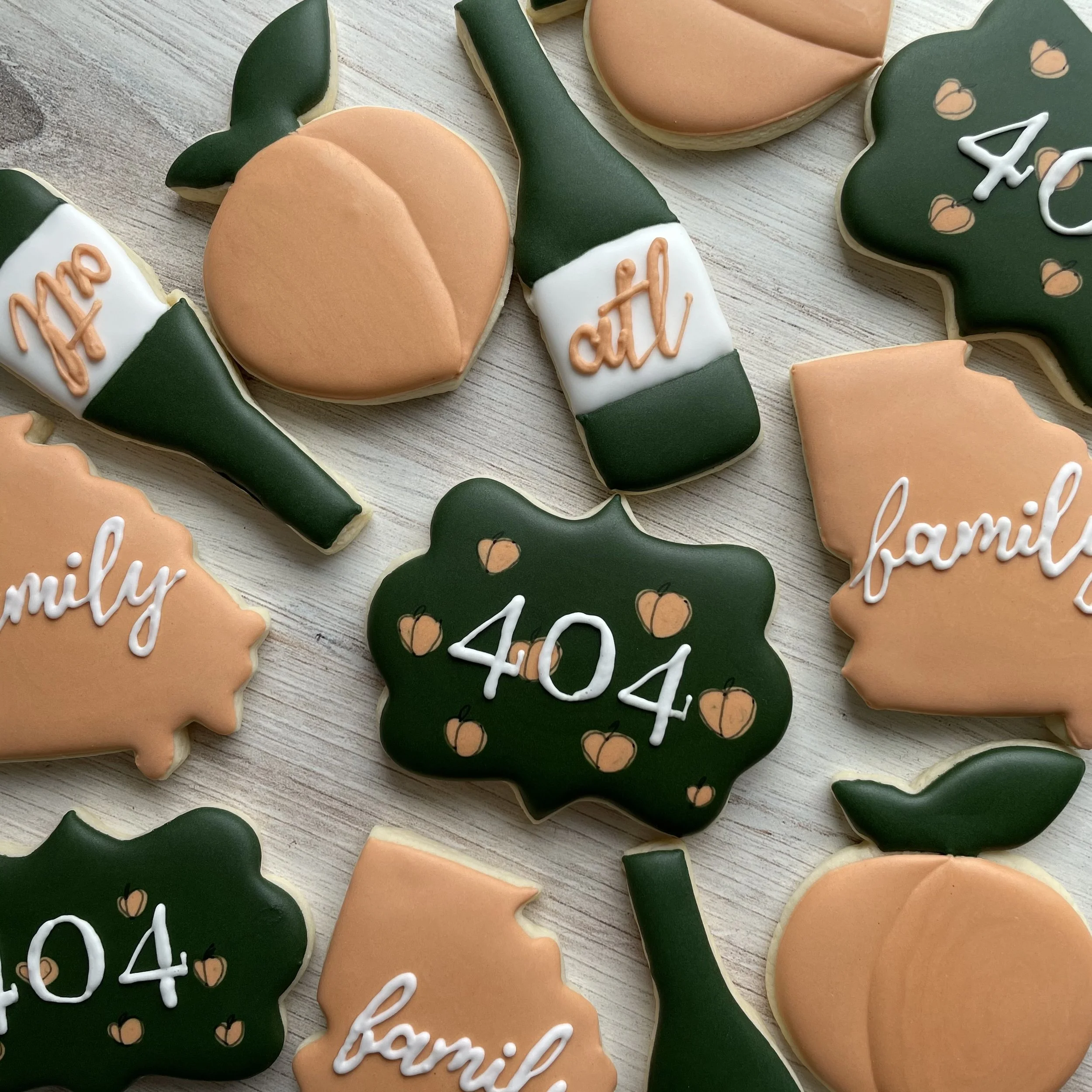 Assorted decorated cookies with fall and Thanksgiving themes, including pumpkins and phrases like 'family' and 'thanks' written with icing.