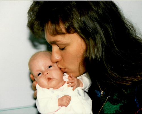 Rita Henry kissing her baby daughter, Julia, on the cheek.