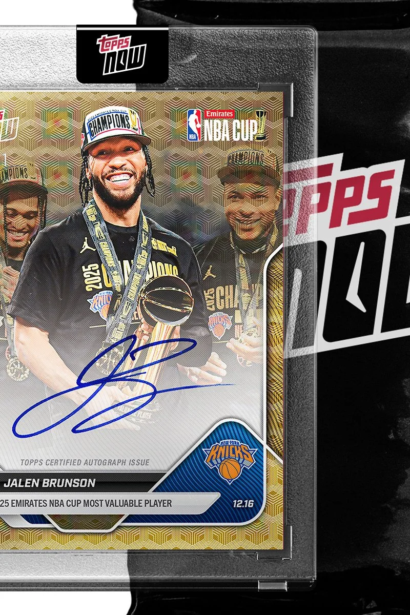A Topps NBA trading card featuring Jalen Brunson, celebrating the New York Knicks' 2023 NBA Championship win. The card displays Brunson with a championship cap, medals, and a signed autograph. The background shows team members and championship graphics.