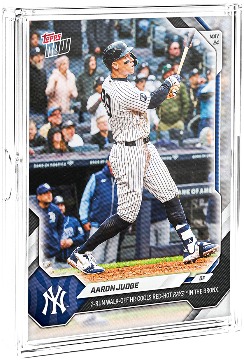A baseball trading card featuring Aaron Judge in a New York Yankees uniform, swinging a bat with fans in the background, and the Yankees logo in the bottom left corner.