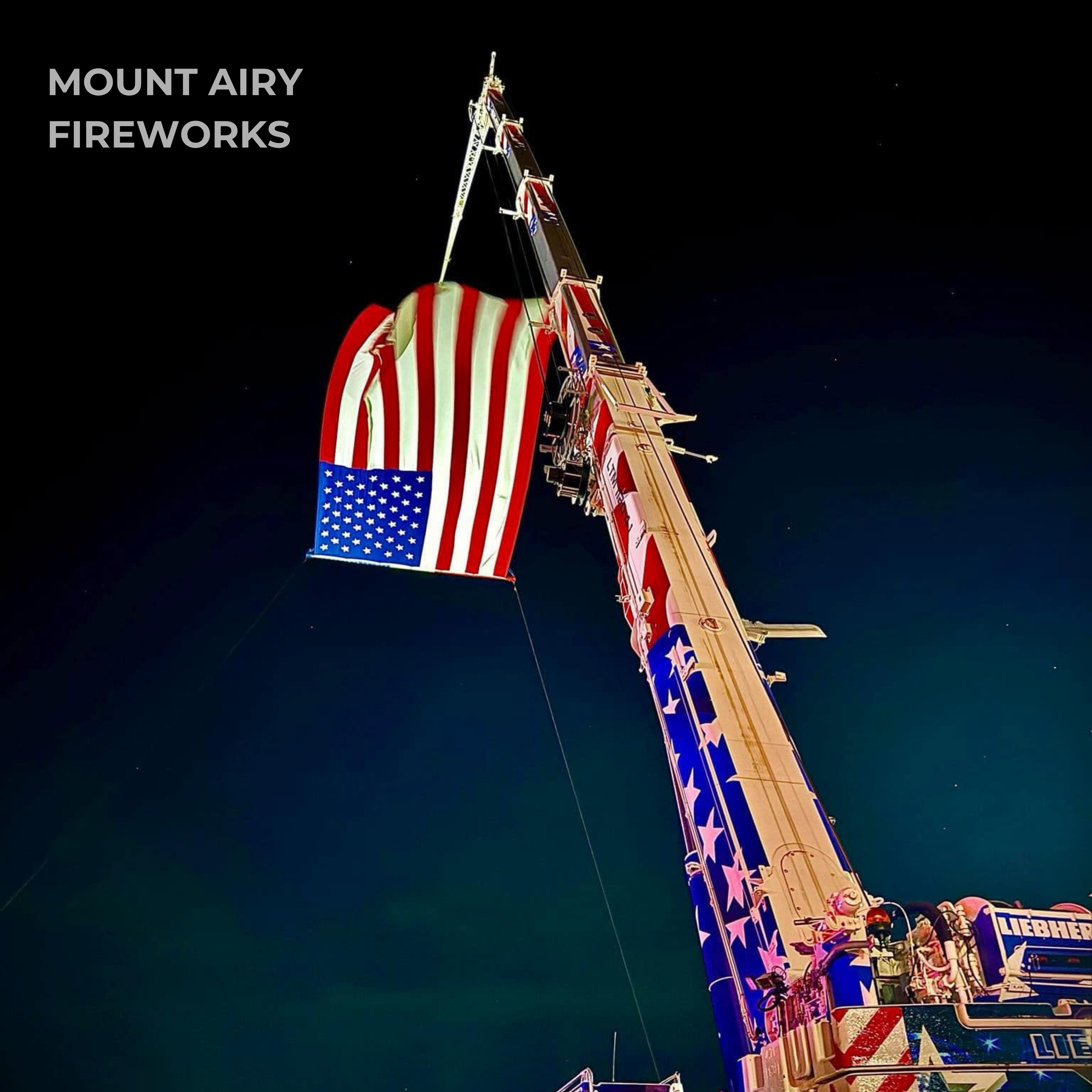 Nighttime view of a the crane holding an american flag at the Mount Airy, Maryland Fireworks event.