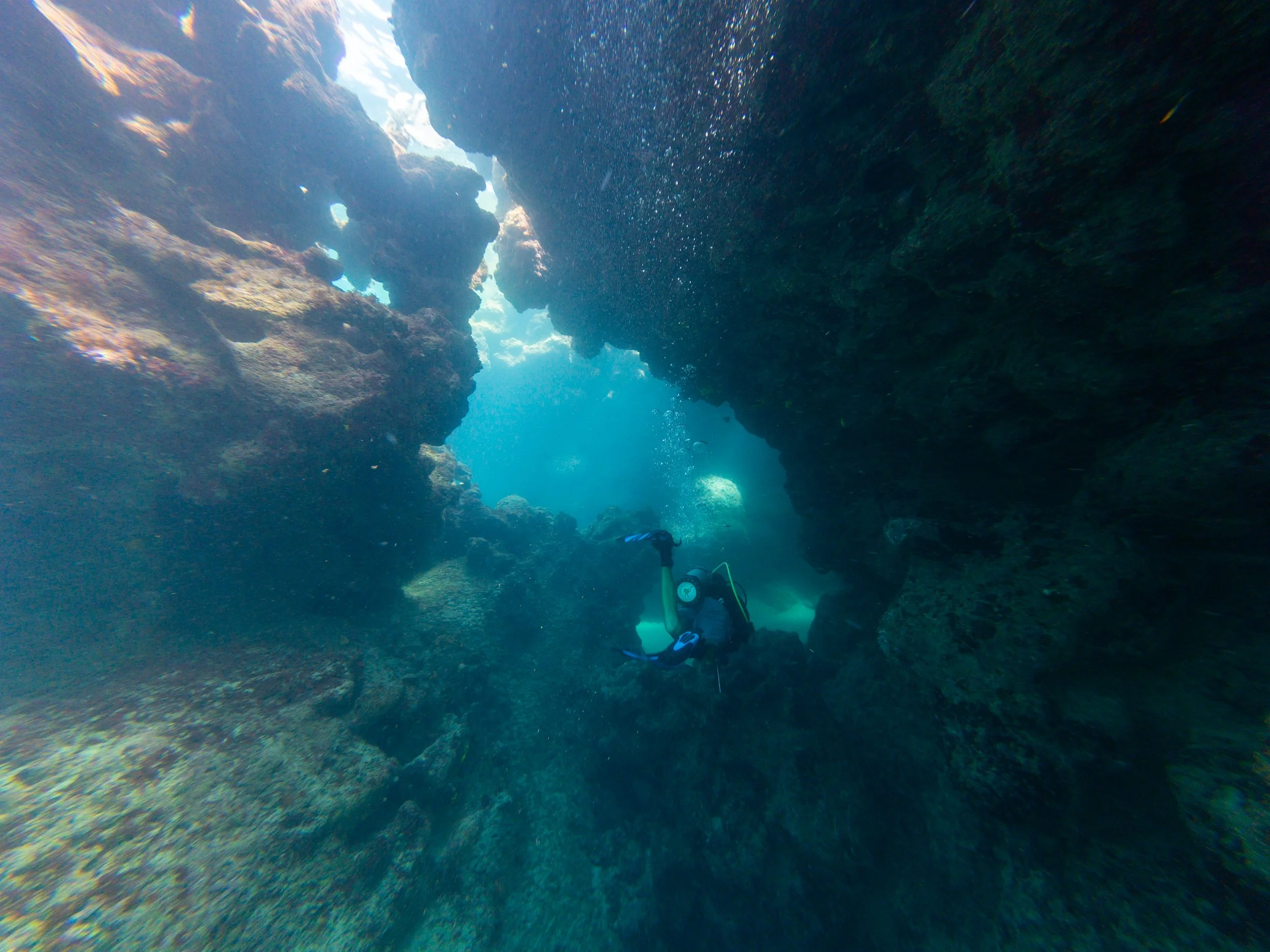 Diver inside a light-filled cavern at Shacks Blue Hole, Isabela, Puerto Rico