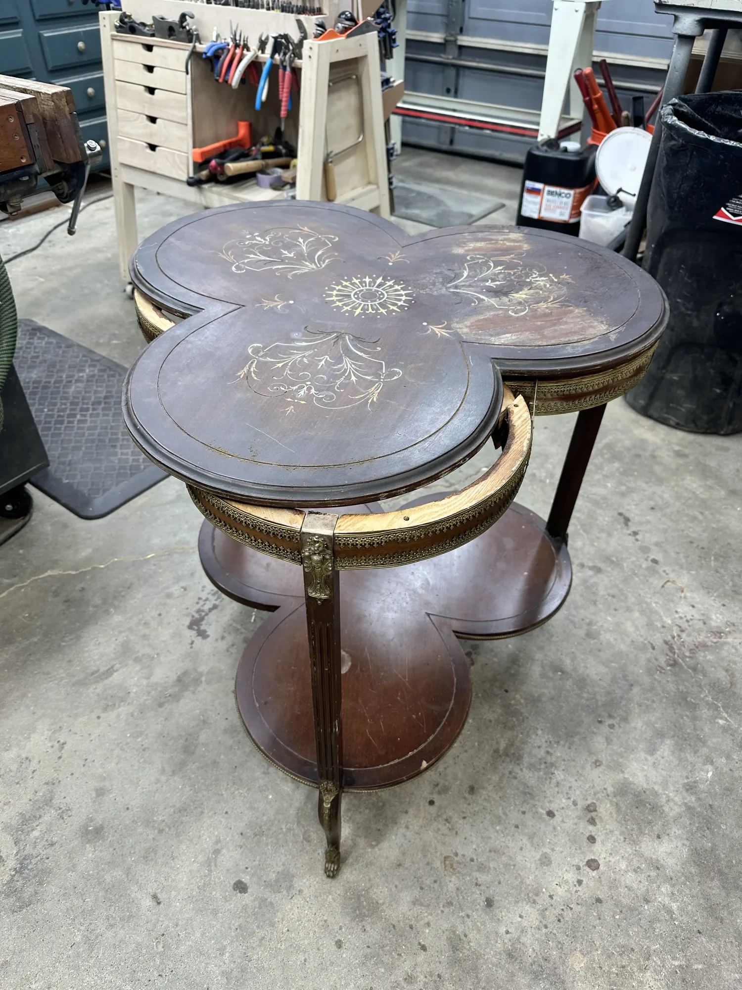 Louis XVI–style trefoil side table before restoration, with faded finish, lifting veneer, and a loose brass gallery