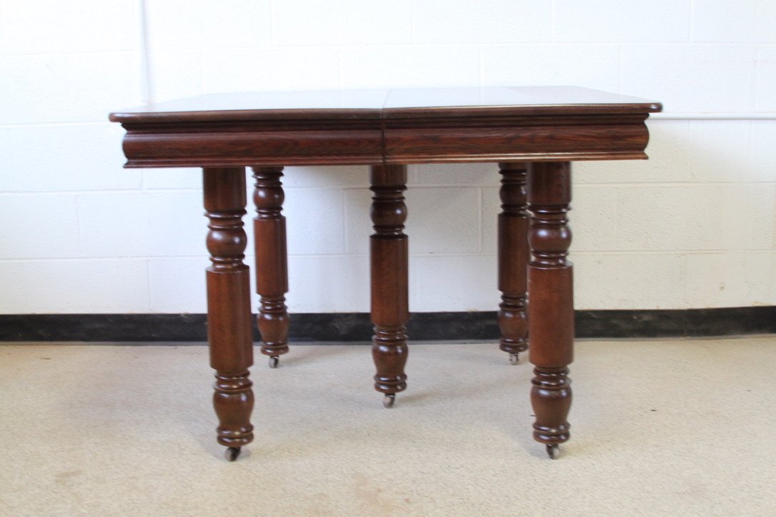 Traditional Wood Dining Table with Turned Legs and Casters