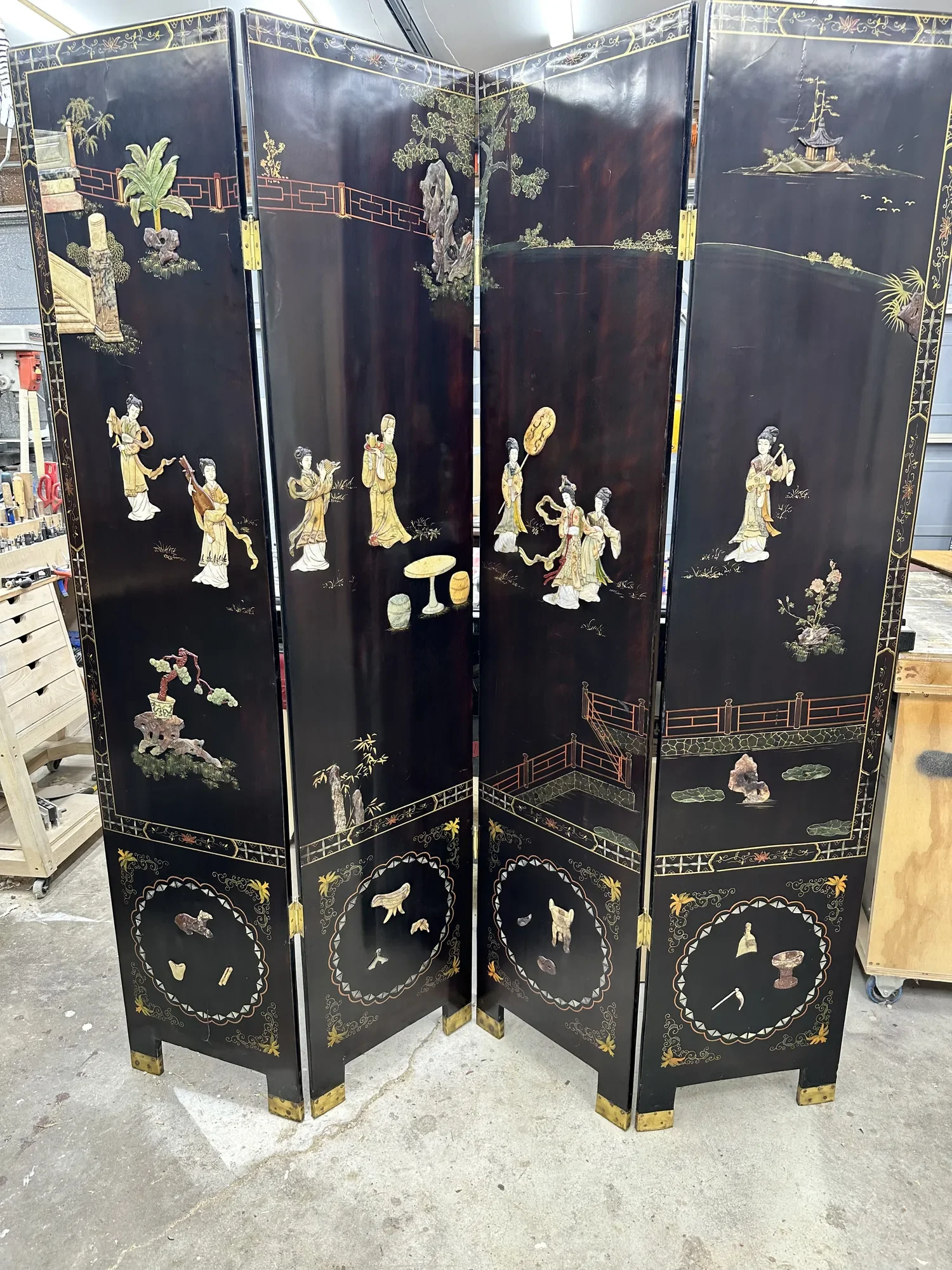 Restored, one of a kind, four-panel Chinese black lacquer screen with carved hardstone court ladies in a garden of pavilions and bridges