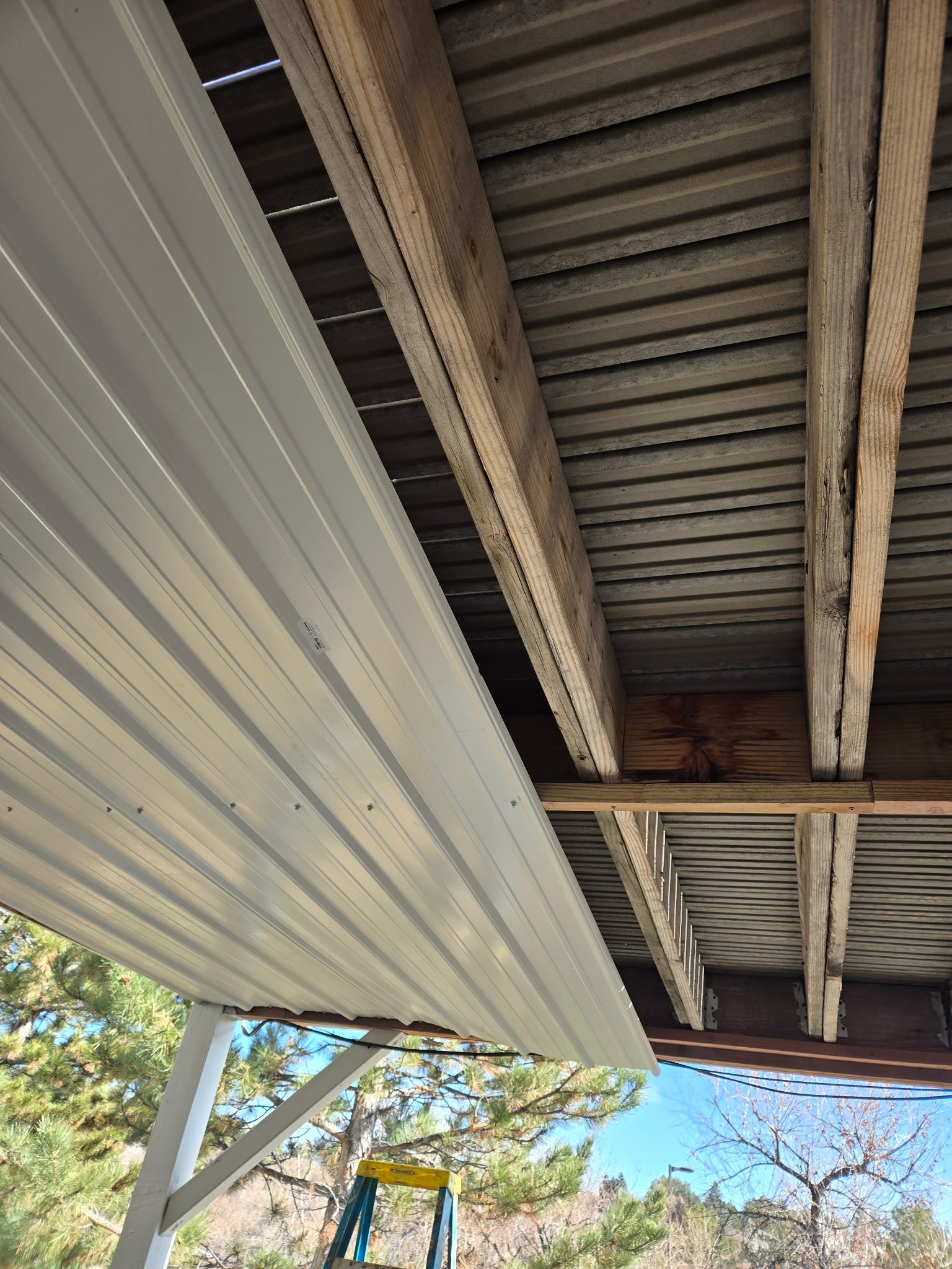 Water mitigation sheeting installation progress. This improvement makes the patio usable on rainy days. Fairplay, CO.