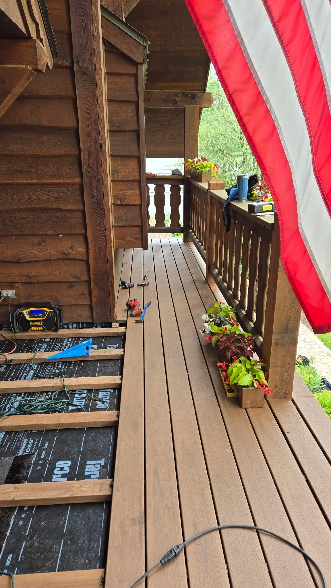 New Trex decking over new membrane roof, flashing, and drip edge installation.