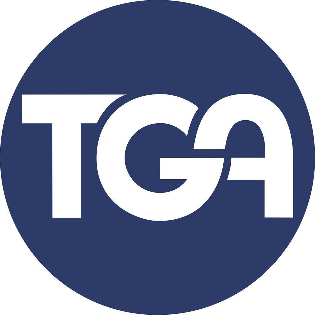 A circular logo with a blue background and white letters spelling 'TGA'. Est. 1948 is partially visible in the design.