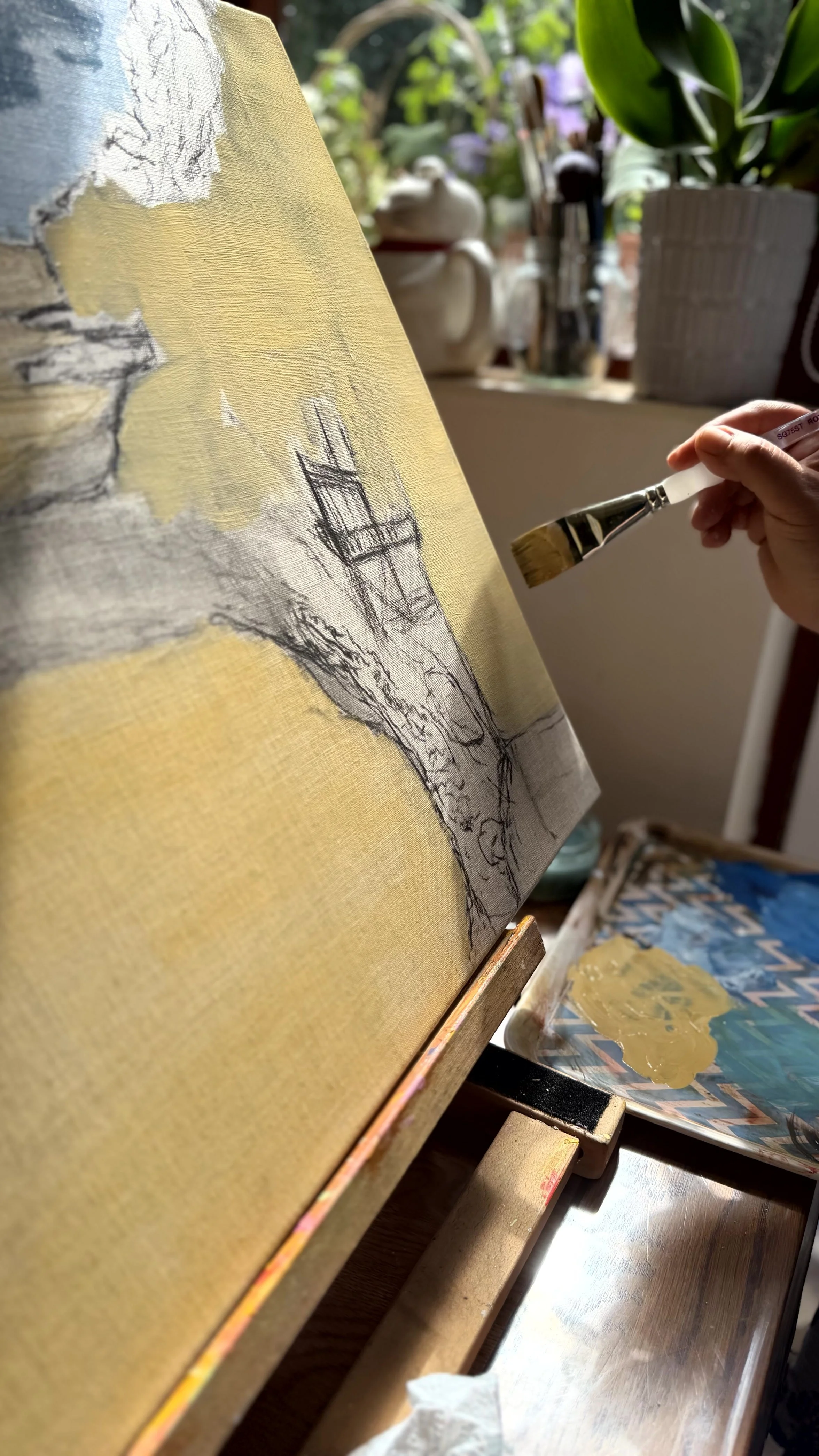 Artist painting in a Dorset studio, showing handmade fine art prints produced and packed in the UK