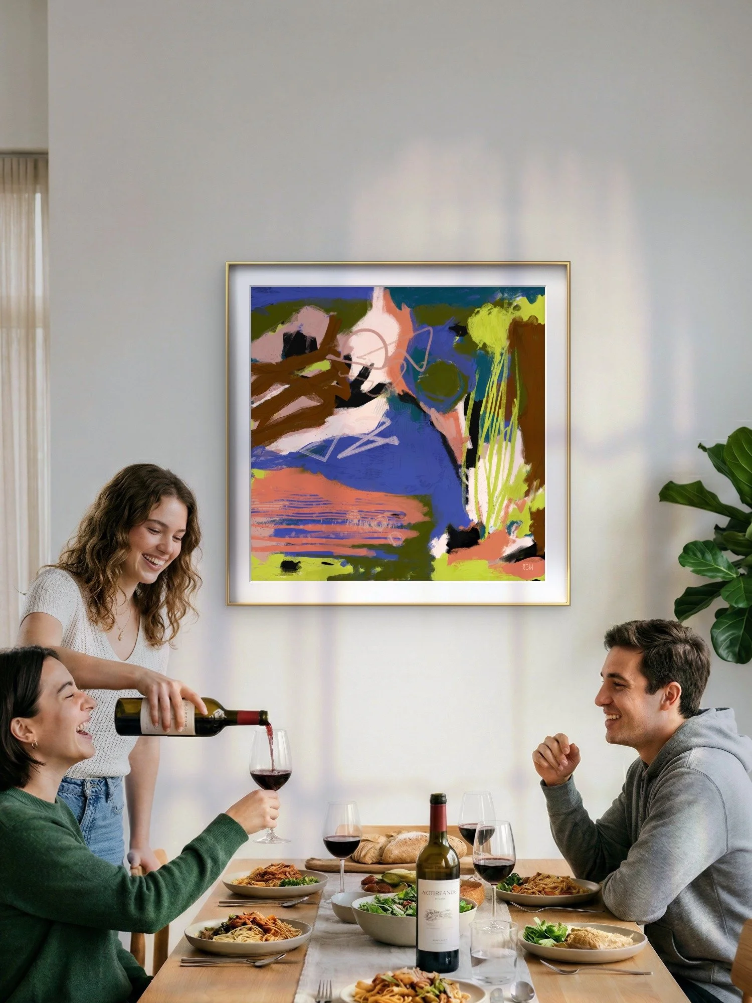 A group of four friends enjoying a meal together at a table with pasta, salad, and wine in a bright, modern dining room with a colorful abstract painting, 'Understory' by Emily Whitish on the wall.