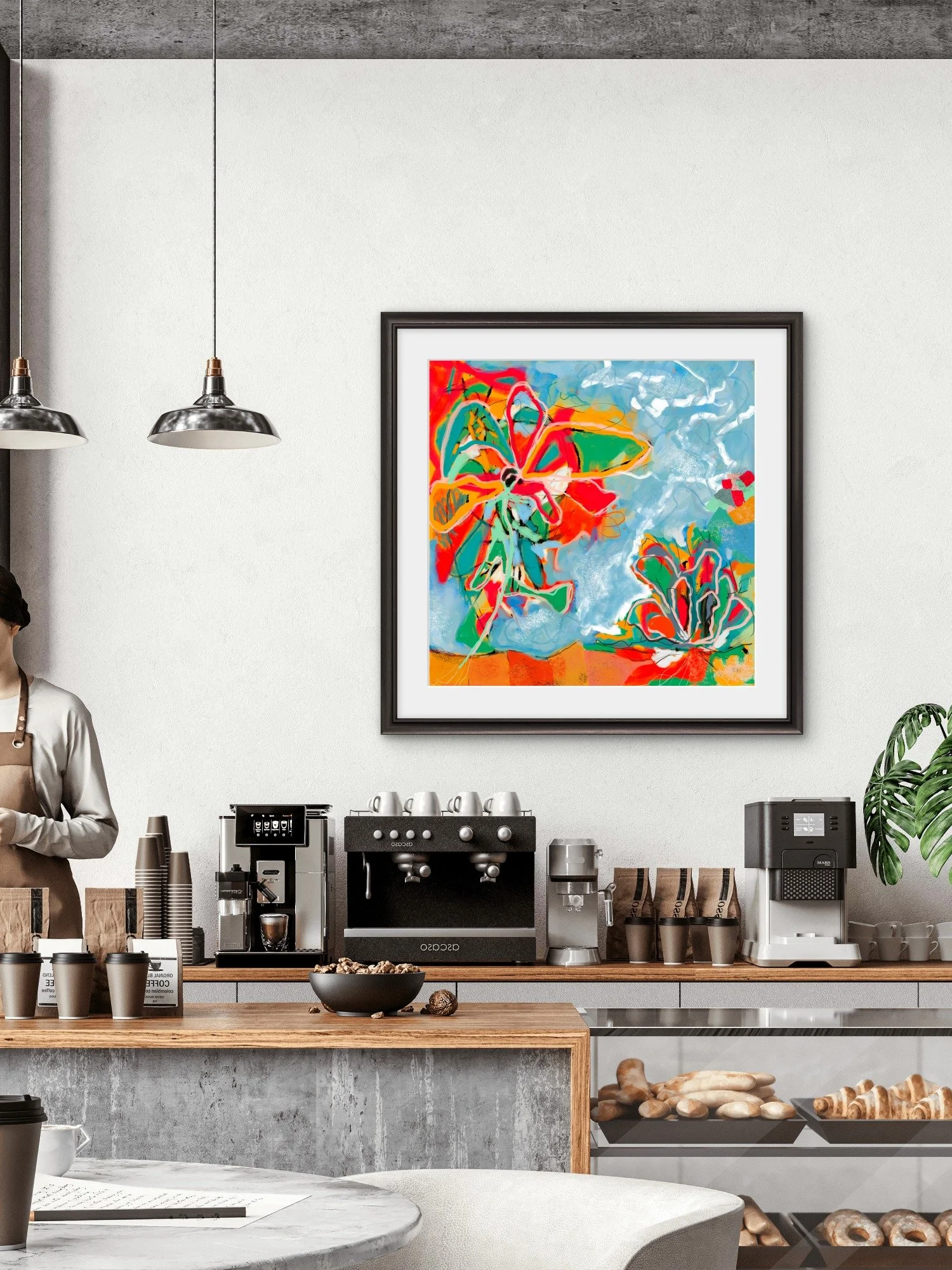 A modern coffee shop interior with a white wall, colorful abstract painting, called 'Caught Fire' by Emily Whitish and coffee-making equipment on a wooden counter.