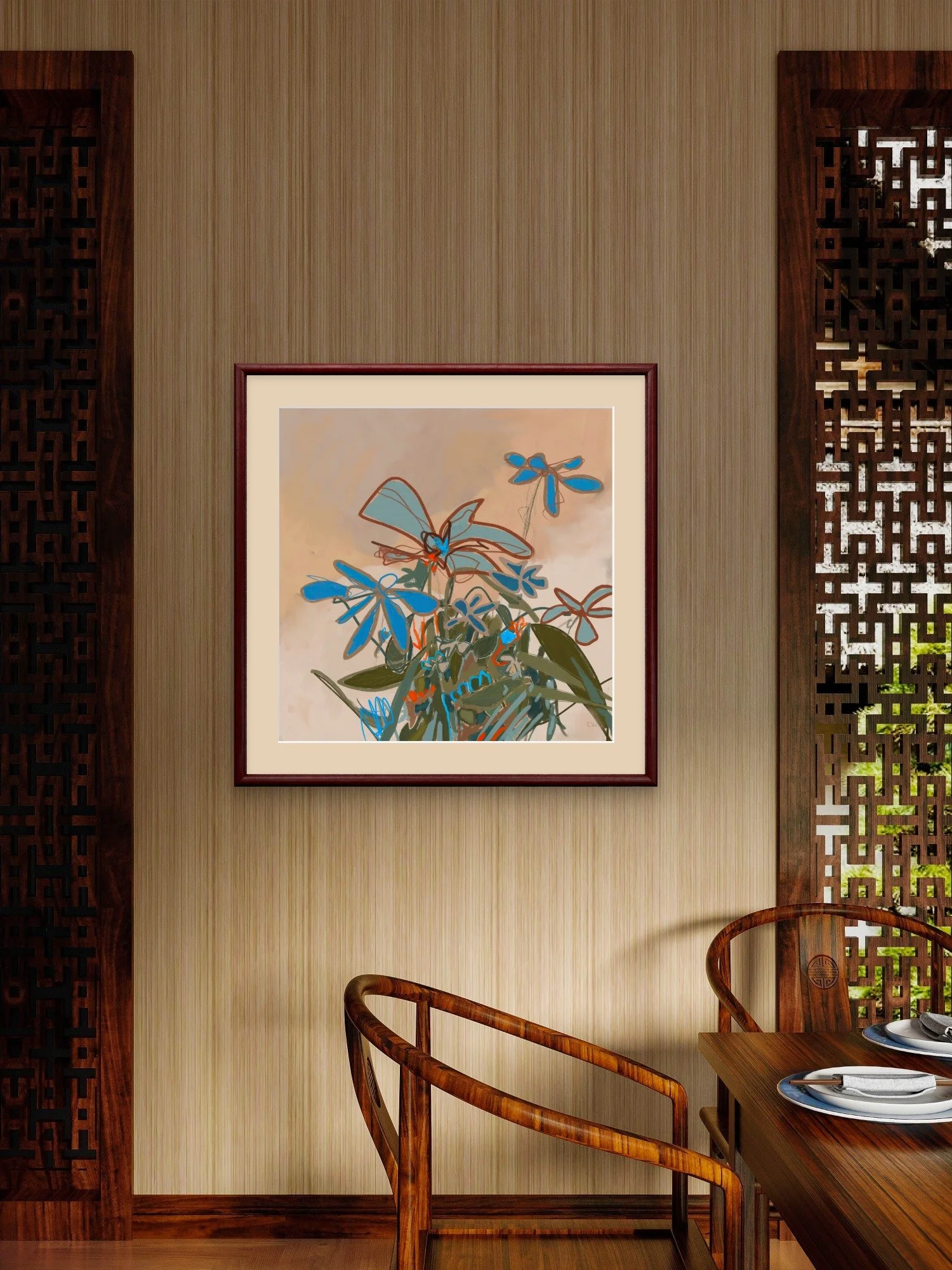 'In Full Feeling,' abstract botanical art print by Emily Whitish hangs framed in a dining area on a beige wall, above wooden chairs, and a table set with plates and utensils.